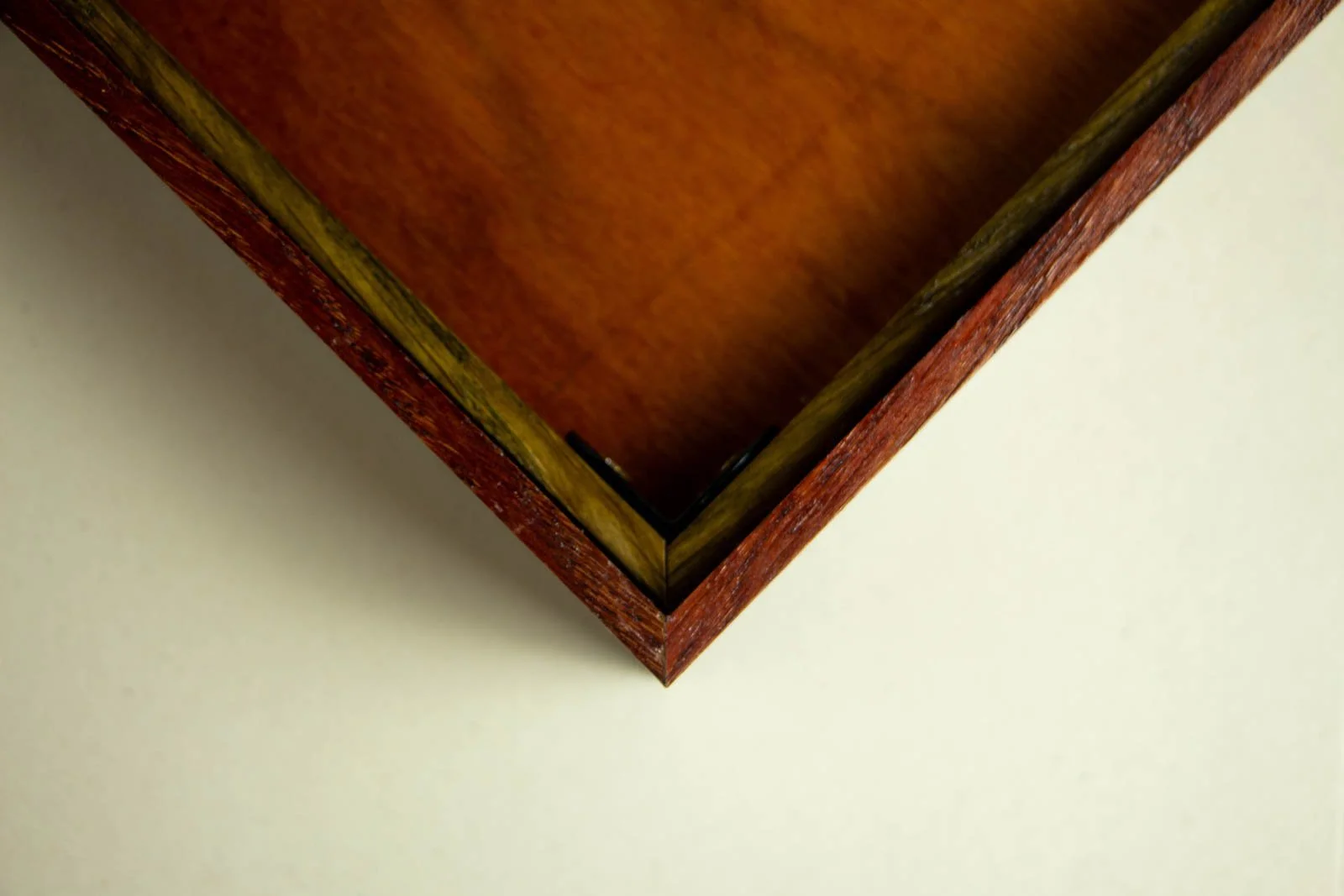 Formless Equation 004 frame back: corner showing profile build-up, wengé band around the side and wire hardware mount