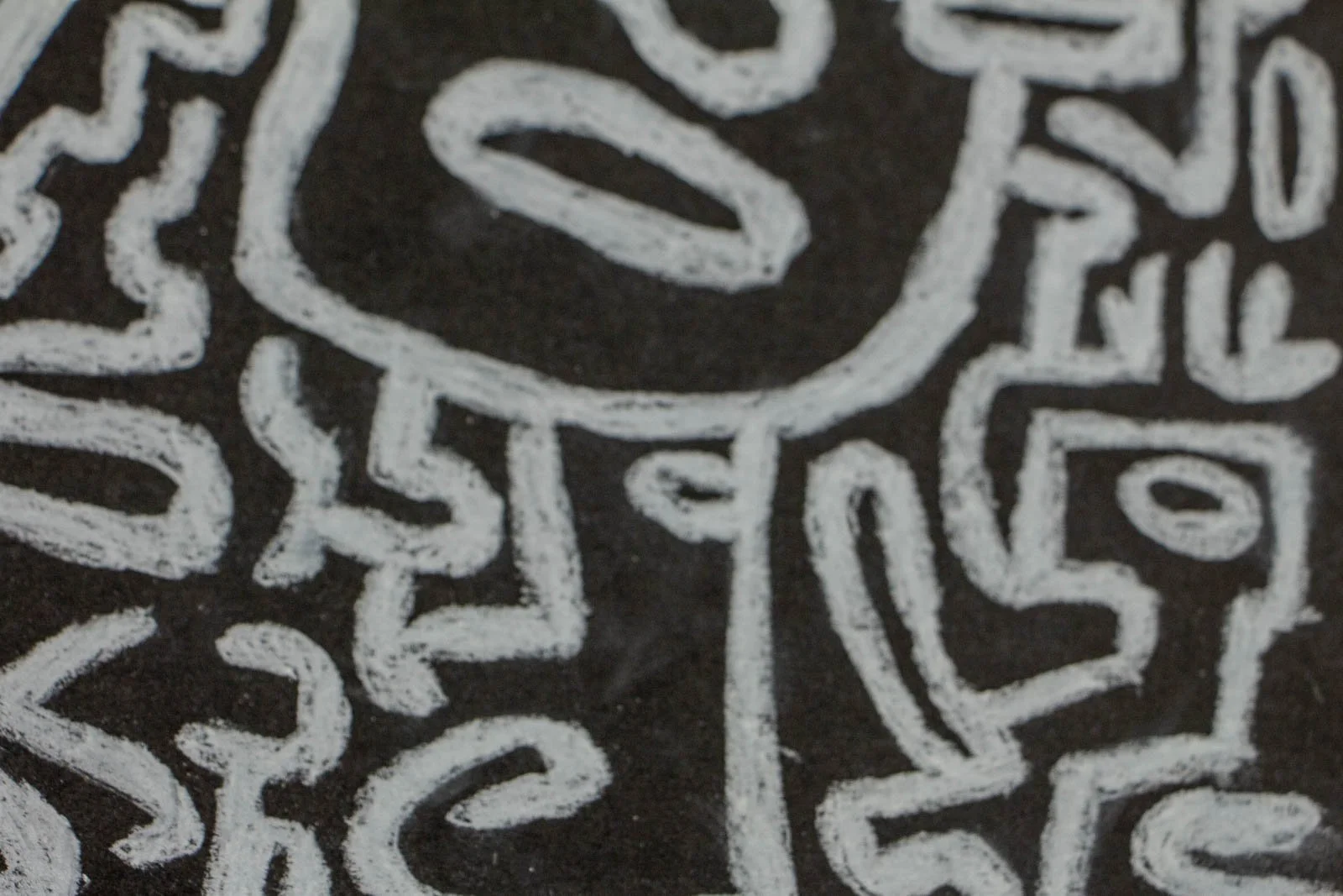 Synaptic Mythos 001 detail: quieter face plane with a single sweeping contour; broad matte-black field lets the paper grain show; sparse marks offset the busier maze above