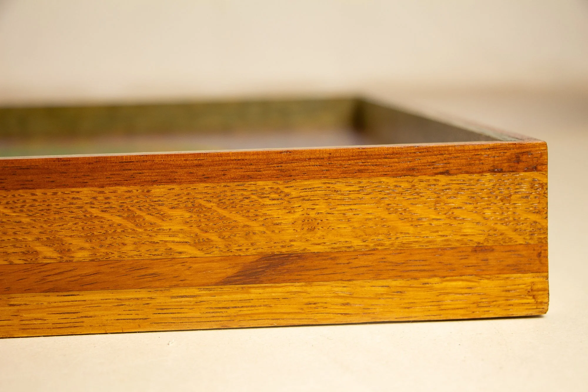 Unseen Signifiers 006 frame detail: close-up of the right-hand frame section, showing the layered bands of golden and reddish-brown wood and the precise vertical edge finish. mahogany, oak and beech wood.