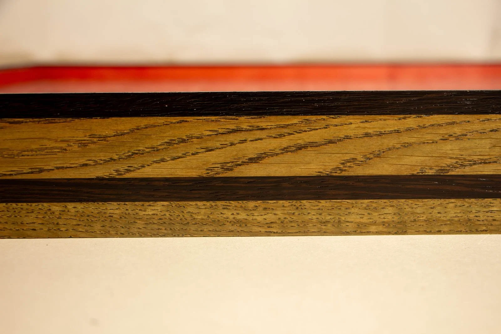 Formless Equation 002 frame: horizontal oak grain with dark wengé inlay band, visible open pores