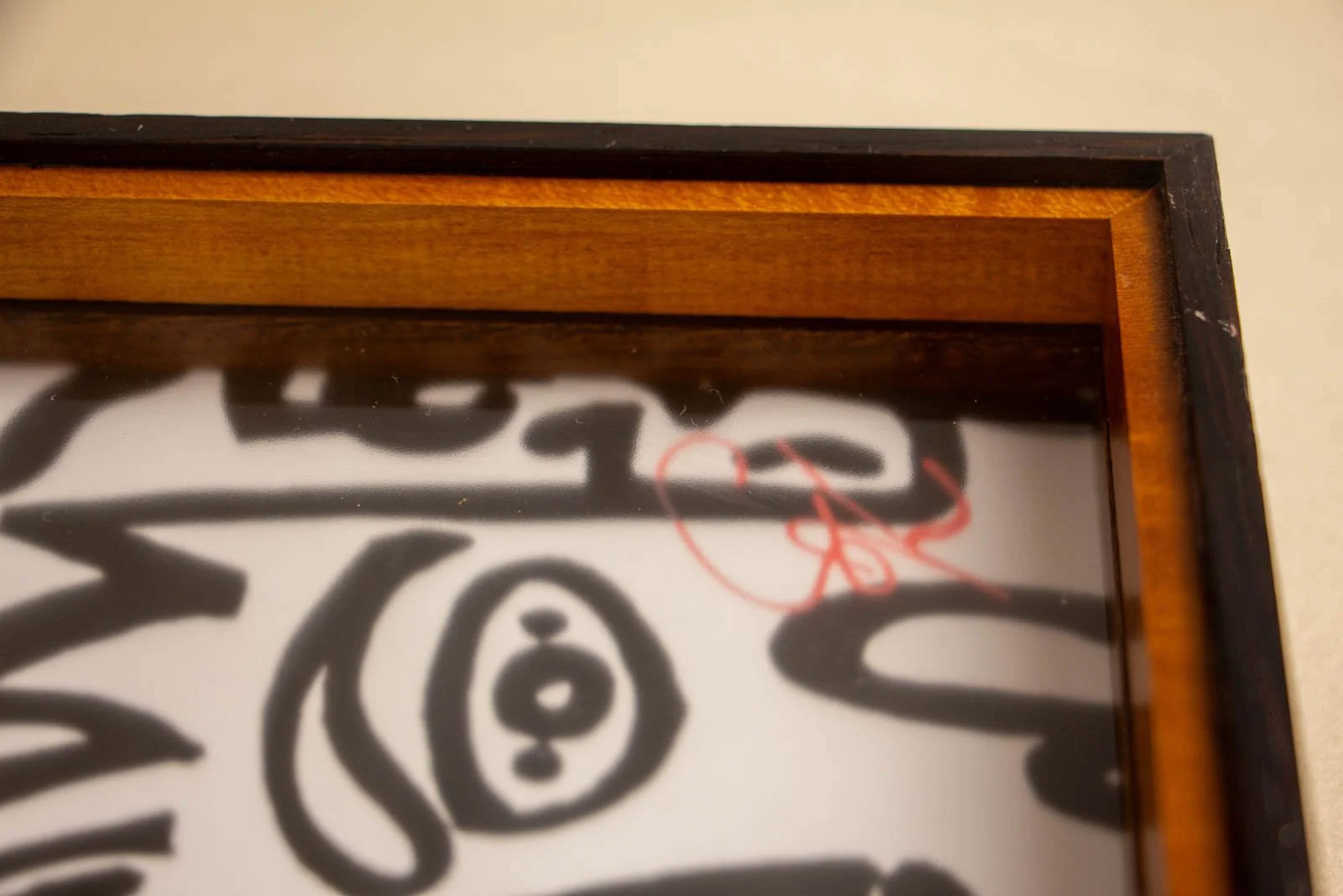 Formless Equation 004 frame: inner rim with glass reflection and red signature visible, wengé lip and cherry oak