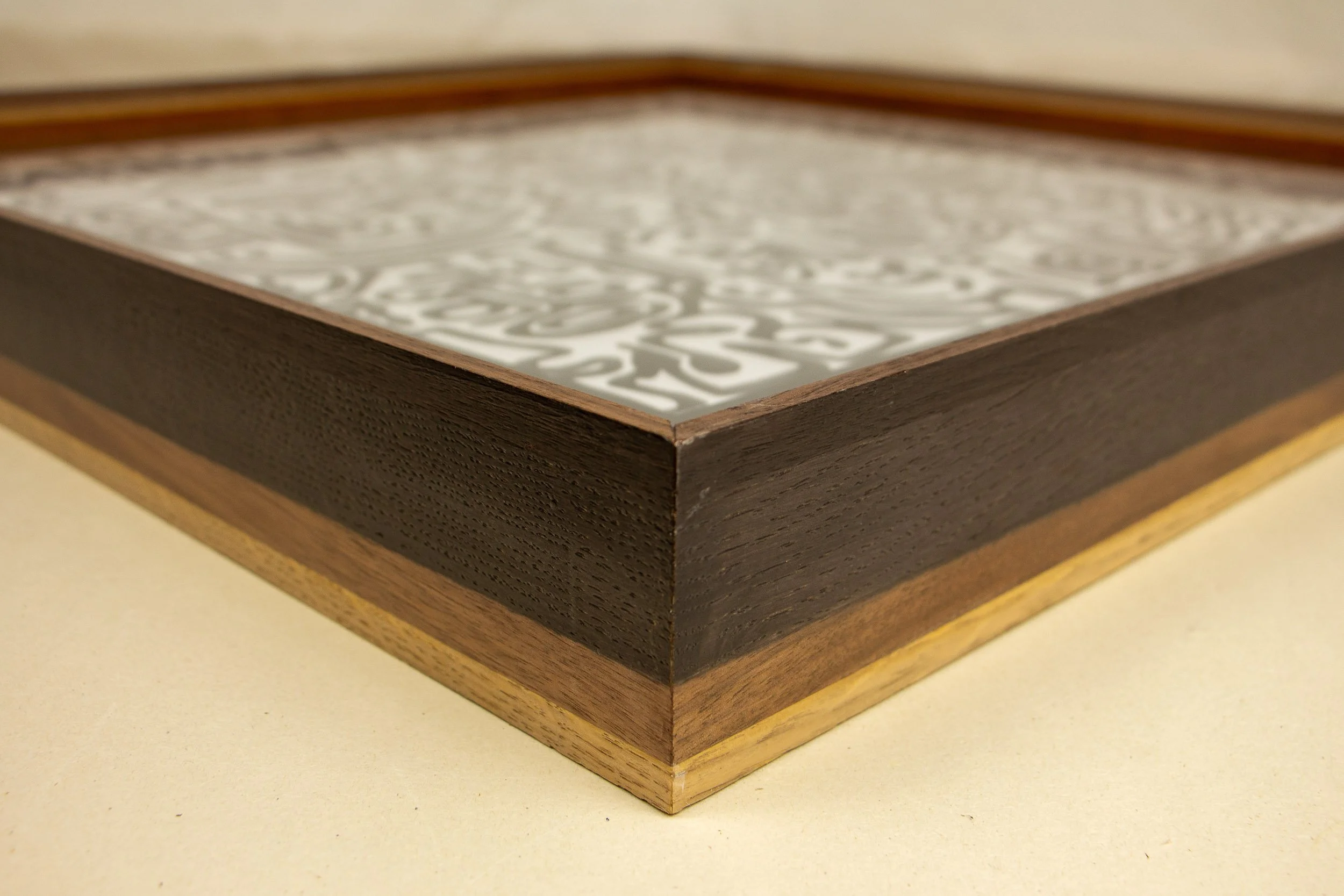 Close-up of a decorative wooden art frame with artwork