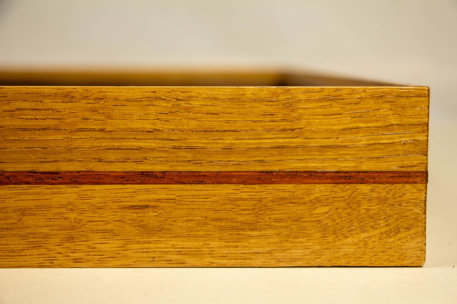 Golden Nostalgia 004 frame: end panel, upper oak tier meeting the side; inlay alignment at the joint