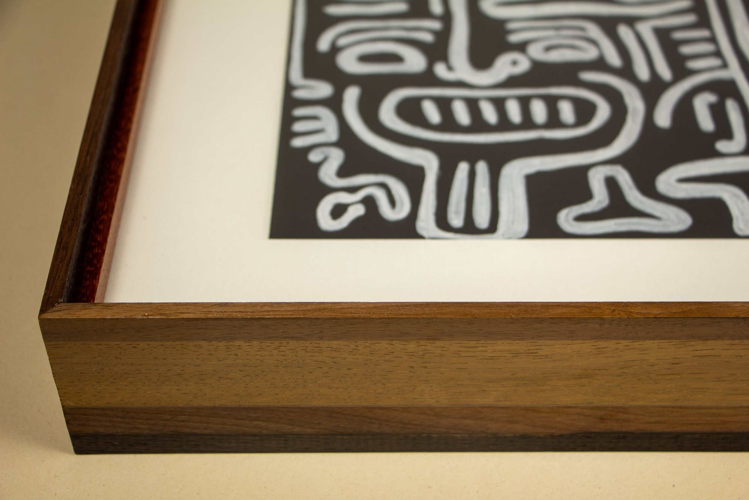 Mêlée of Discovery 001 frame: front corner detail with the artwork visible inside, showing how the broad outer frame, warm inner lip, and image opening come together in one continuous construction.