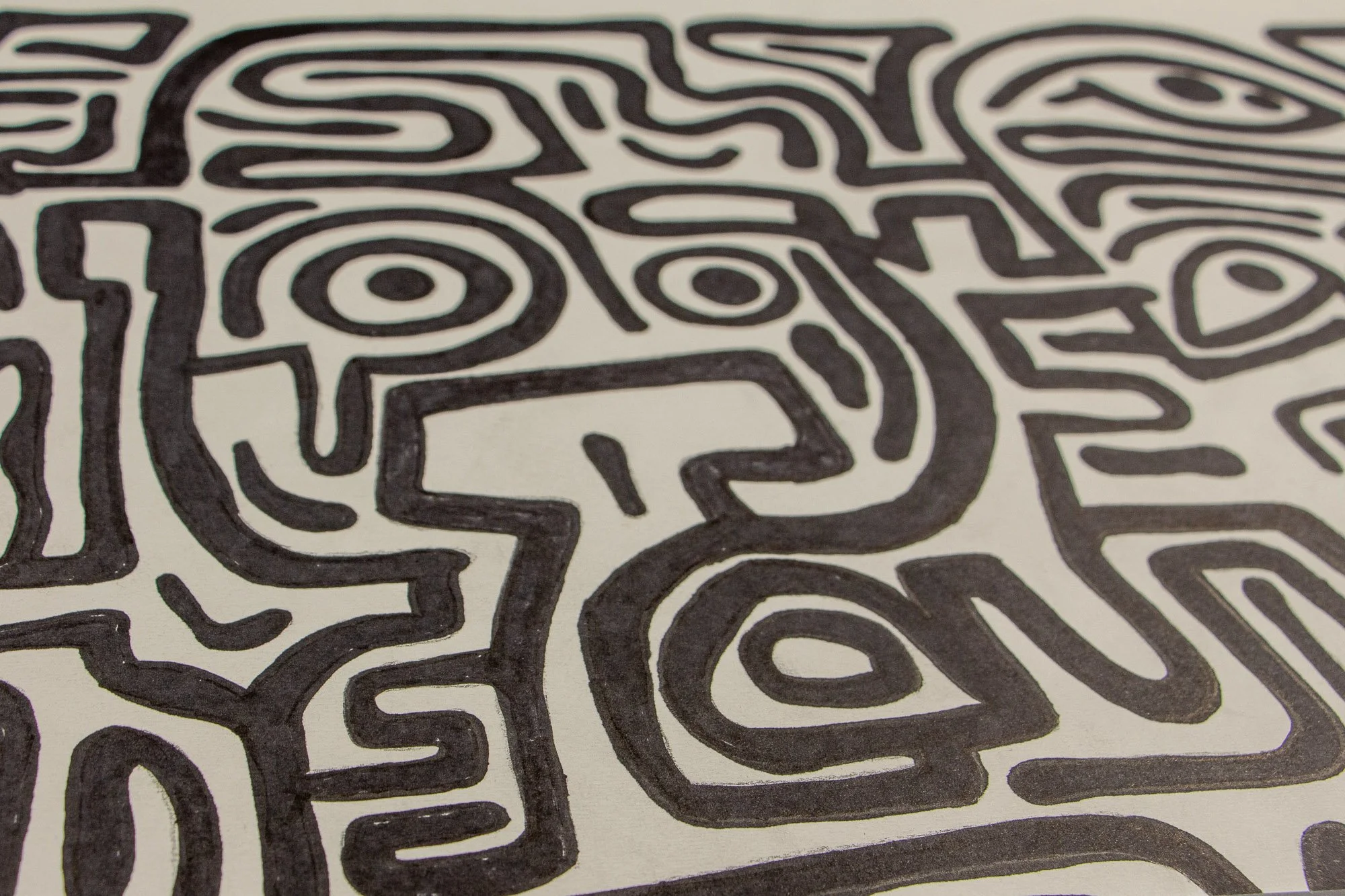 Resonant Syntax 003 detail: angled close-up of a broad facial structure with layered eye motifs, curved contours, and adjoining linear forms; black ink lines moving in a dense, connected rhythm