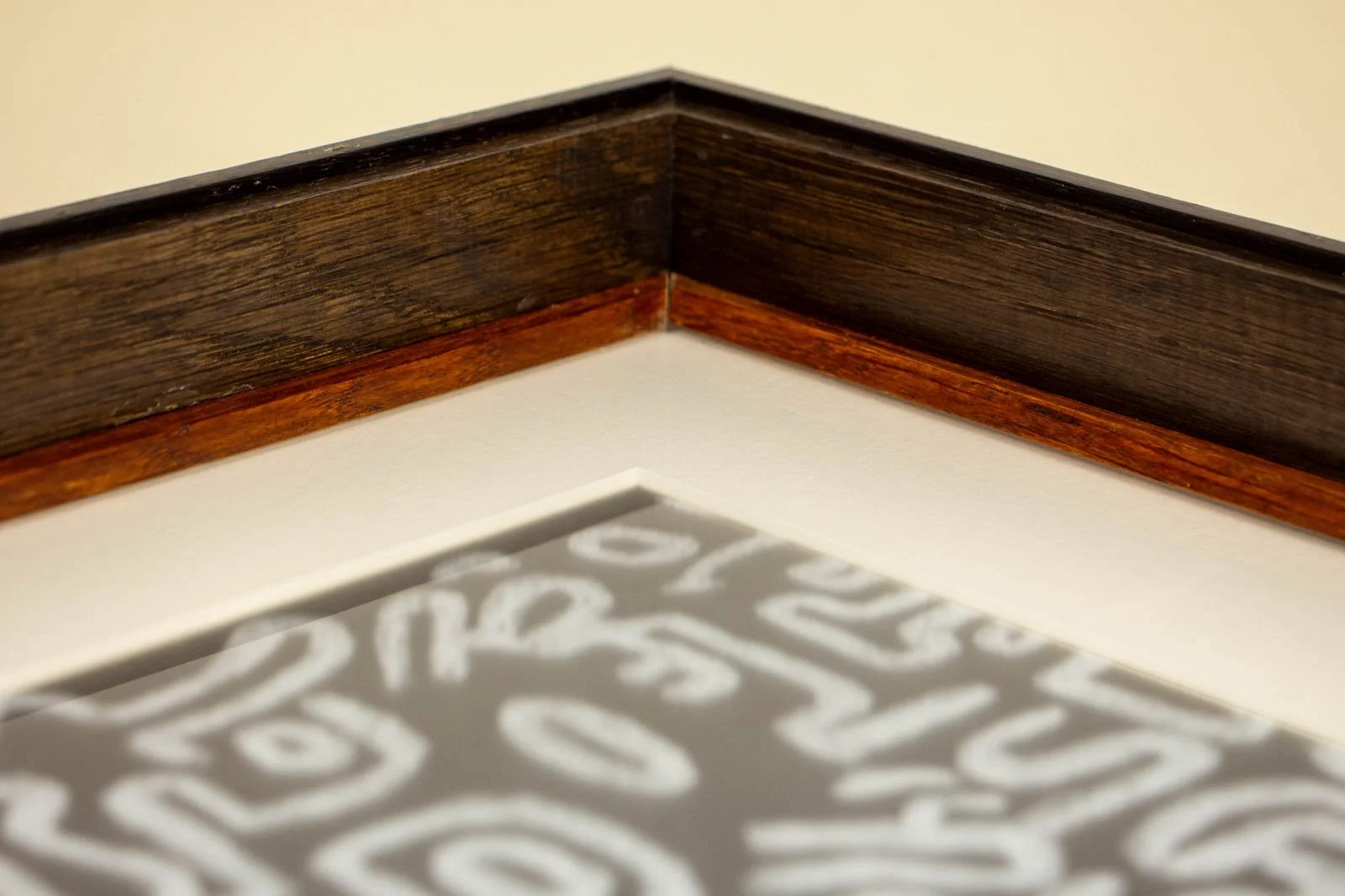 Synaptic Mythos 003 frame: inner throat, warm amber/brown liner running the perimeter; off-white window mat and bevel under the dark cap