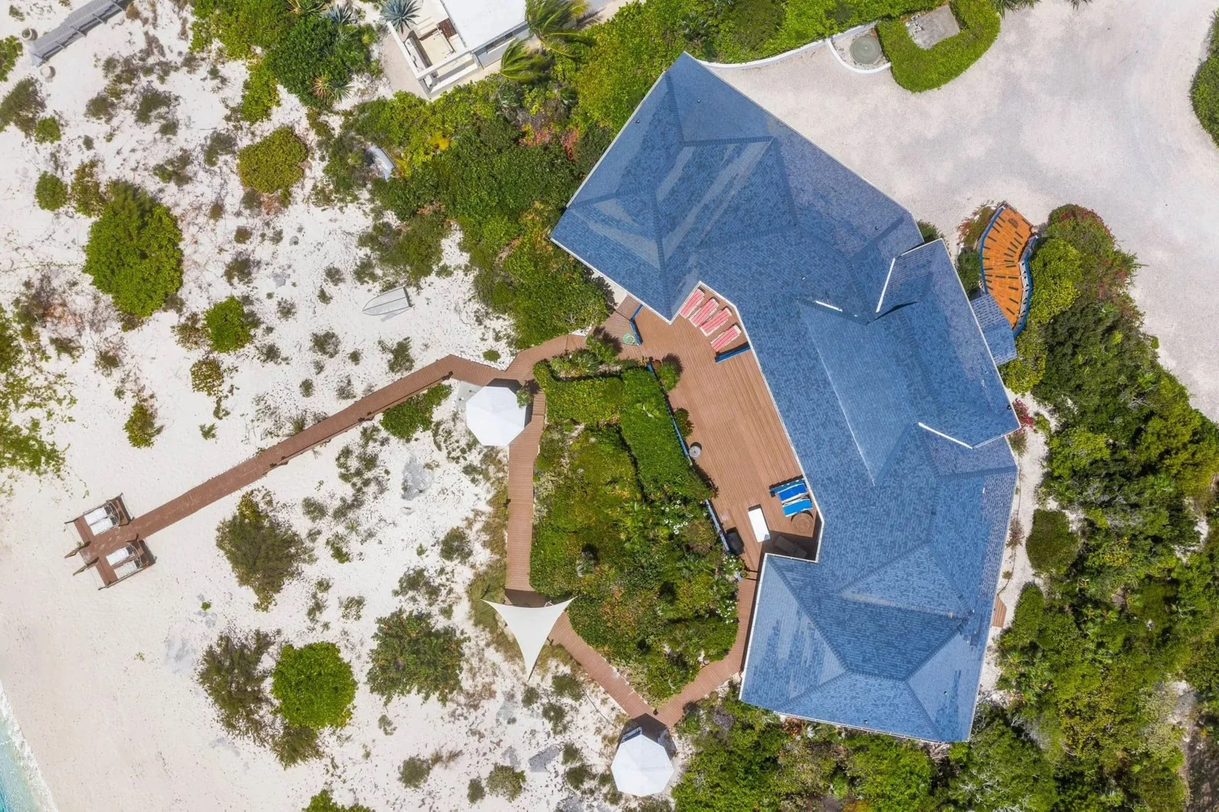 Existing site - top-down aerial showing the residence, garden, retained gazebos and shoreline before the pool proposal.