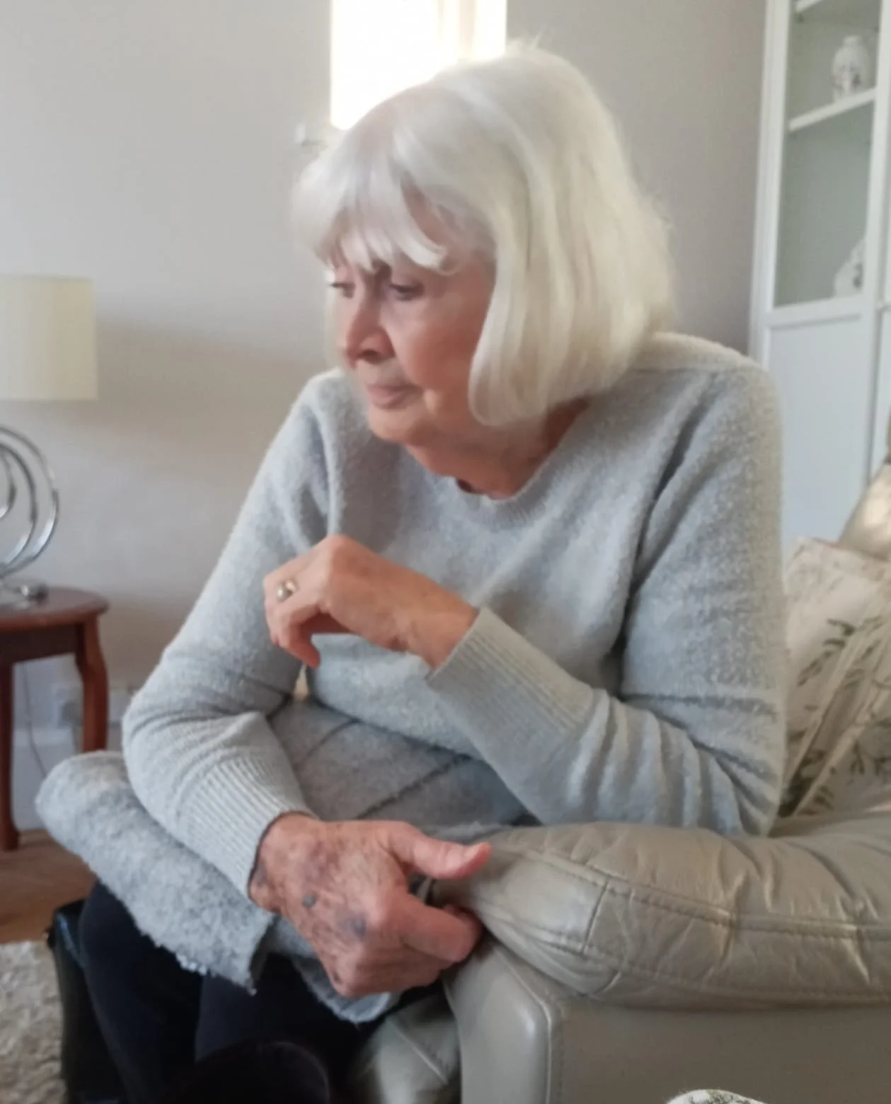 This photograph captures Brenda in a quiet, reflective moment, but as it stands, it isn’t ideal for use as a memorial portrait. The image suffers from several quality issues; the focus is a little soft, particularly around the face, and the overall l
