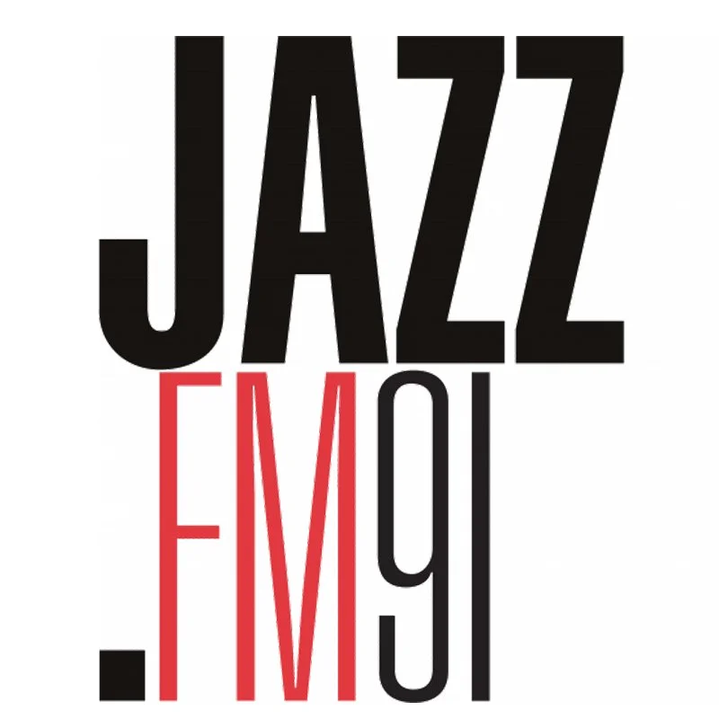 Text logo with the words 'Jazz FM 91' in black and red letters.