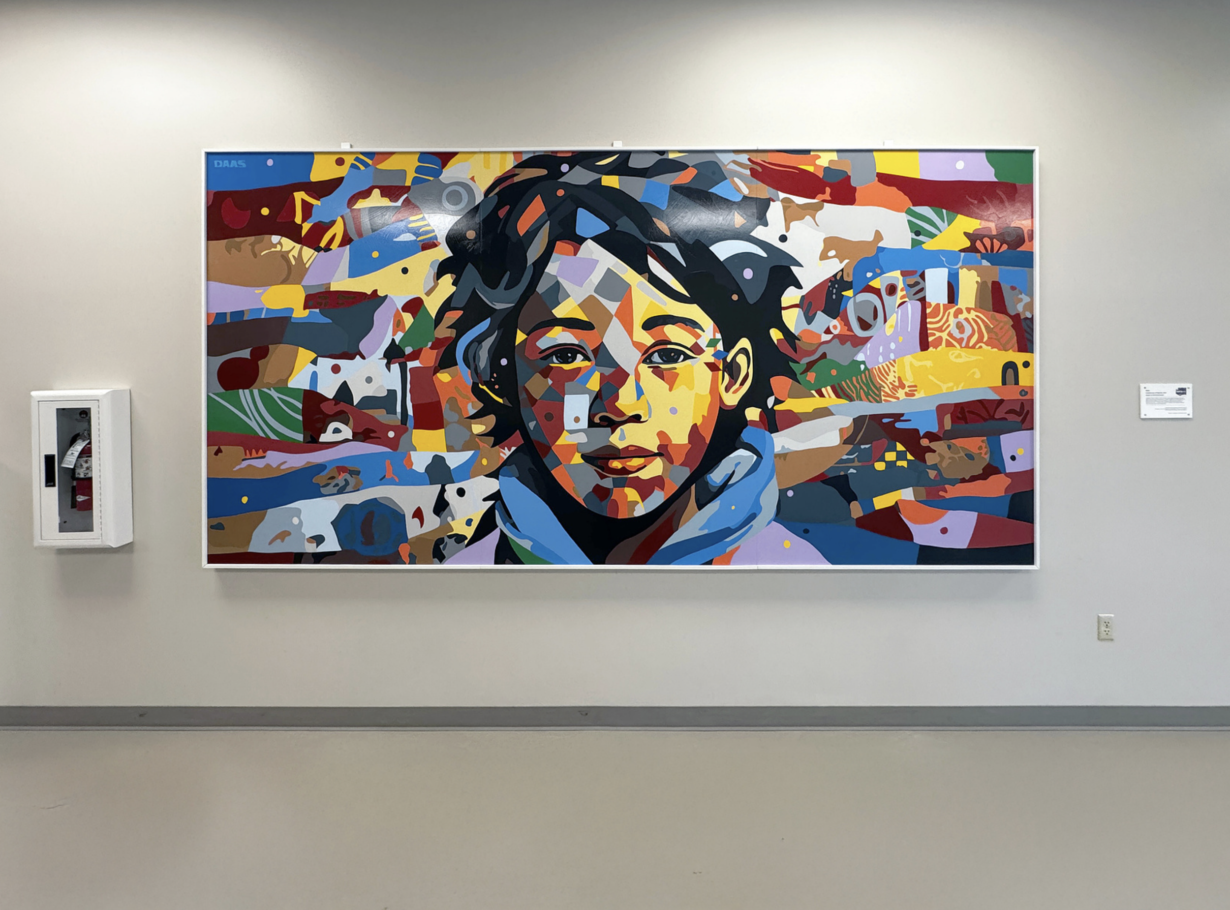 Work by the artist DAAS, Colorful abstract portrait of a young girl with short hair, painted in a modern, geometric style.
