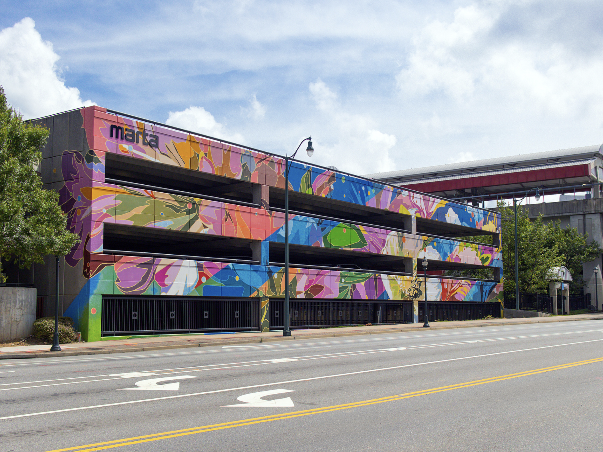 Work by the artist DAAS, Colorful mural mural painted on a building facade in an urban area.