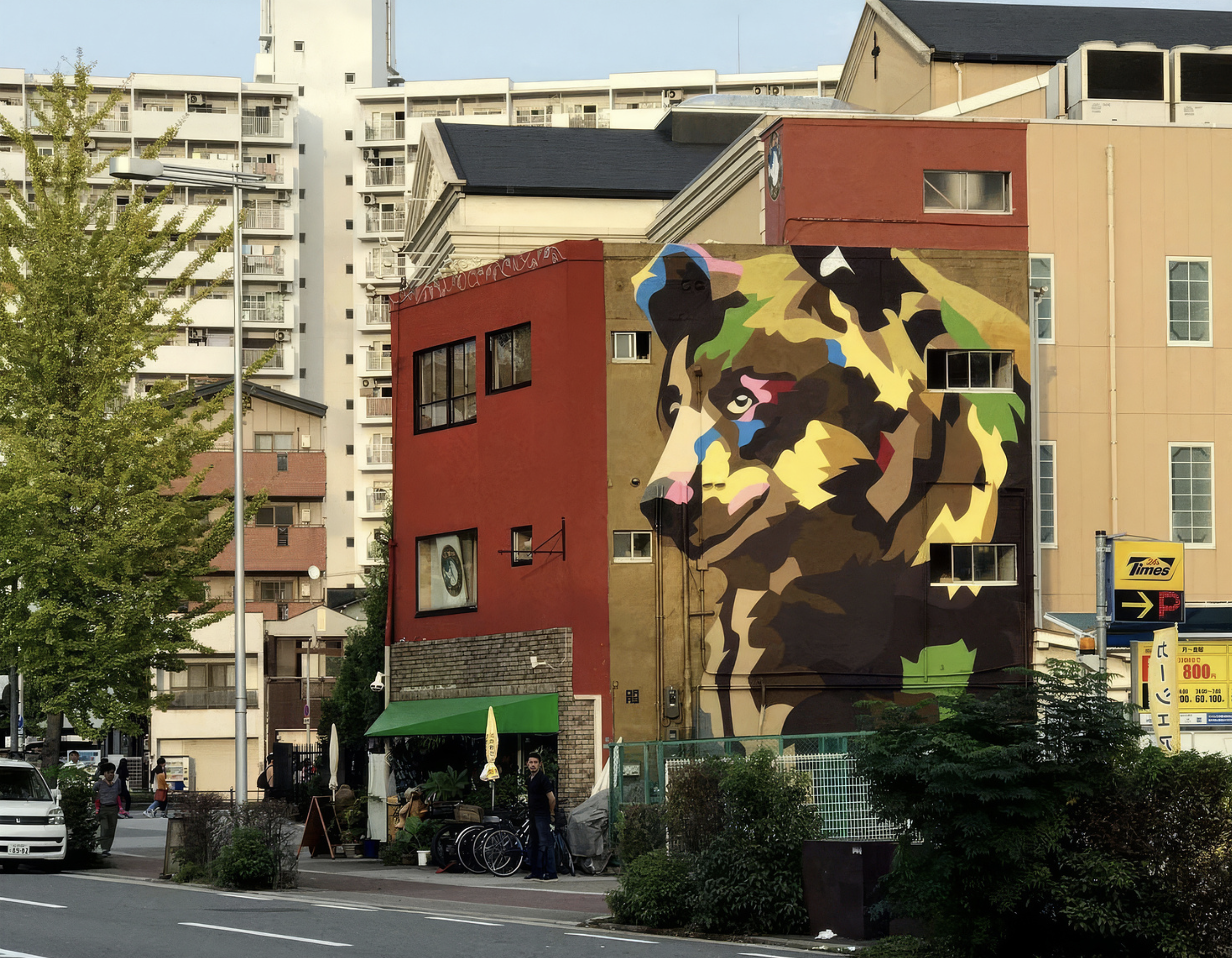 Work by the artist DAAS, Building with a colorful mural of a lion painted on the side.