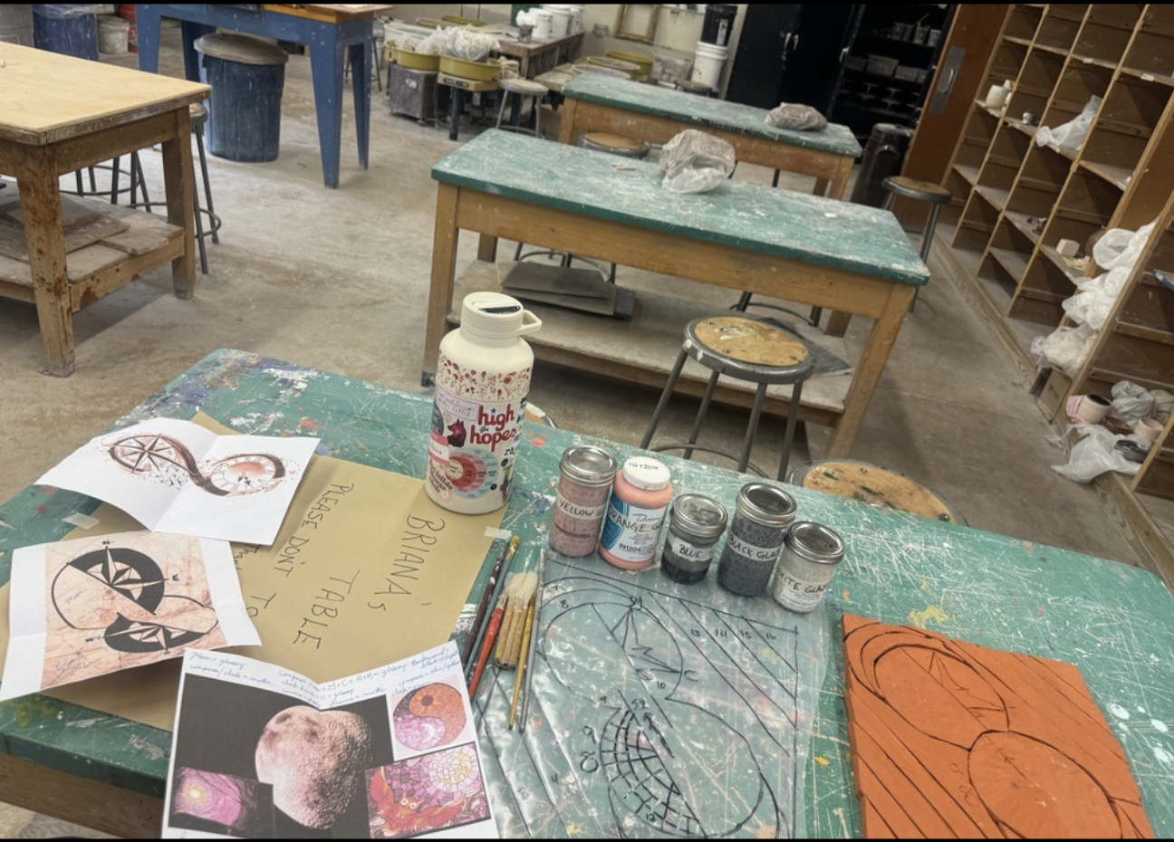 Clay with drawing on it surrounded by inspirational photos