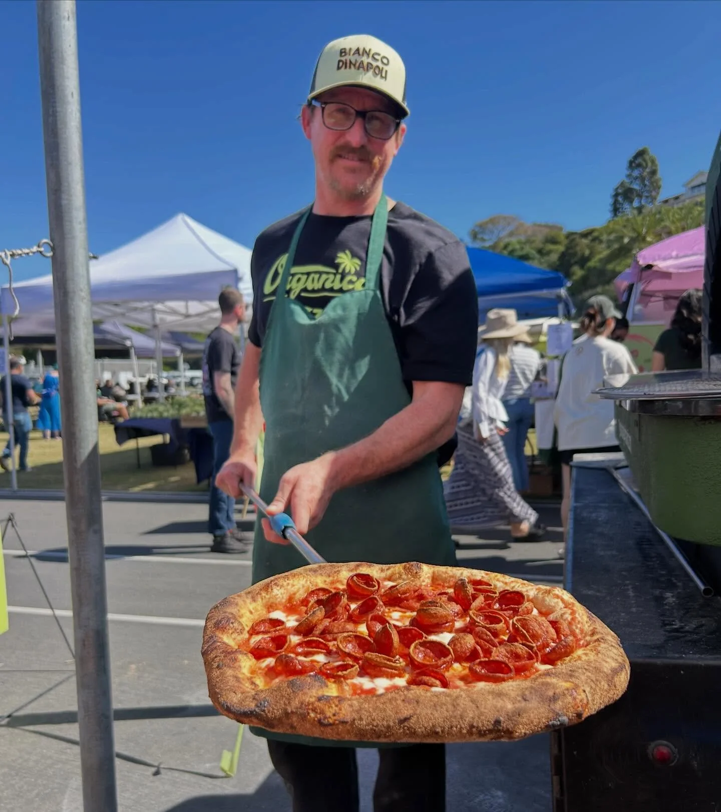 🍕🩵🌻Blake flaunting a freshly baked pepperoni from @lajollaopenairemarket on Sunday! Swing by every Sunday from 9AM-1PM and taste the magic! Come say hi and grab a pizza! #woodfire #pizza #neapolitan #sandiego