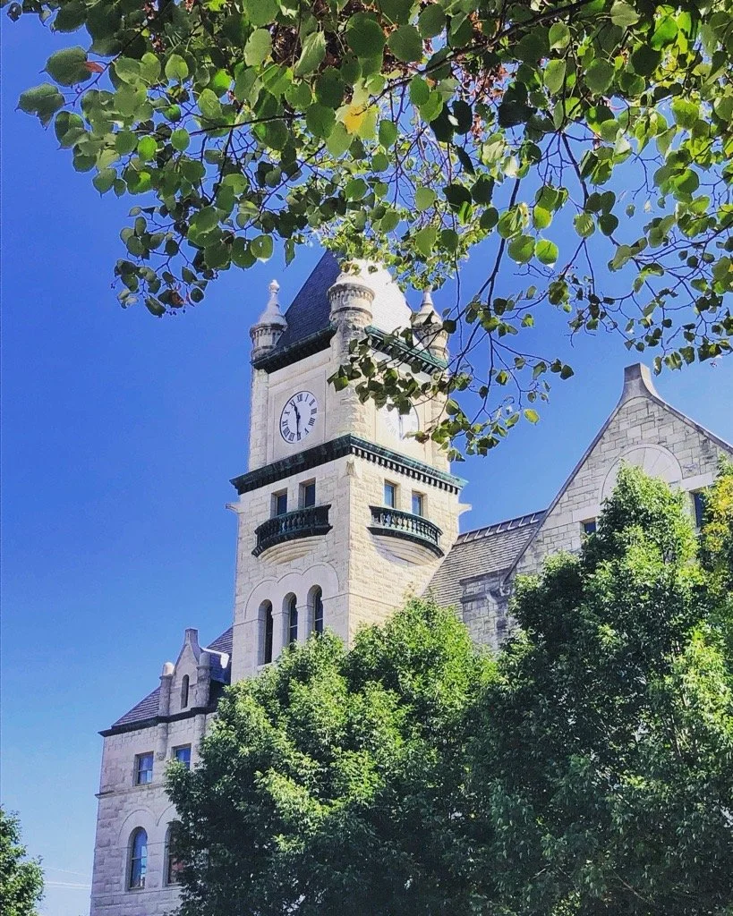 white stone courthouse building with clock