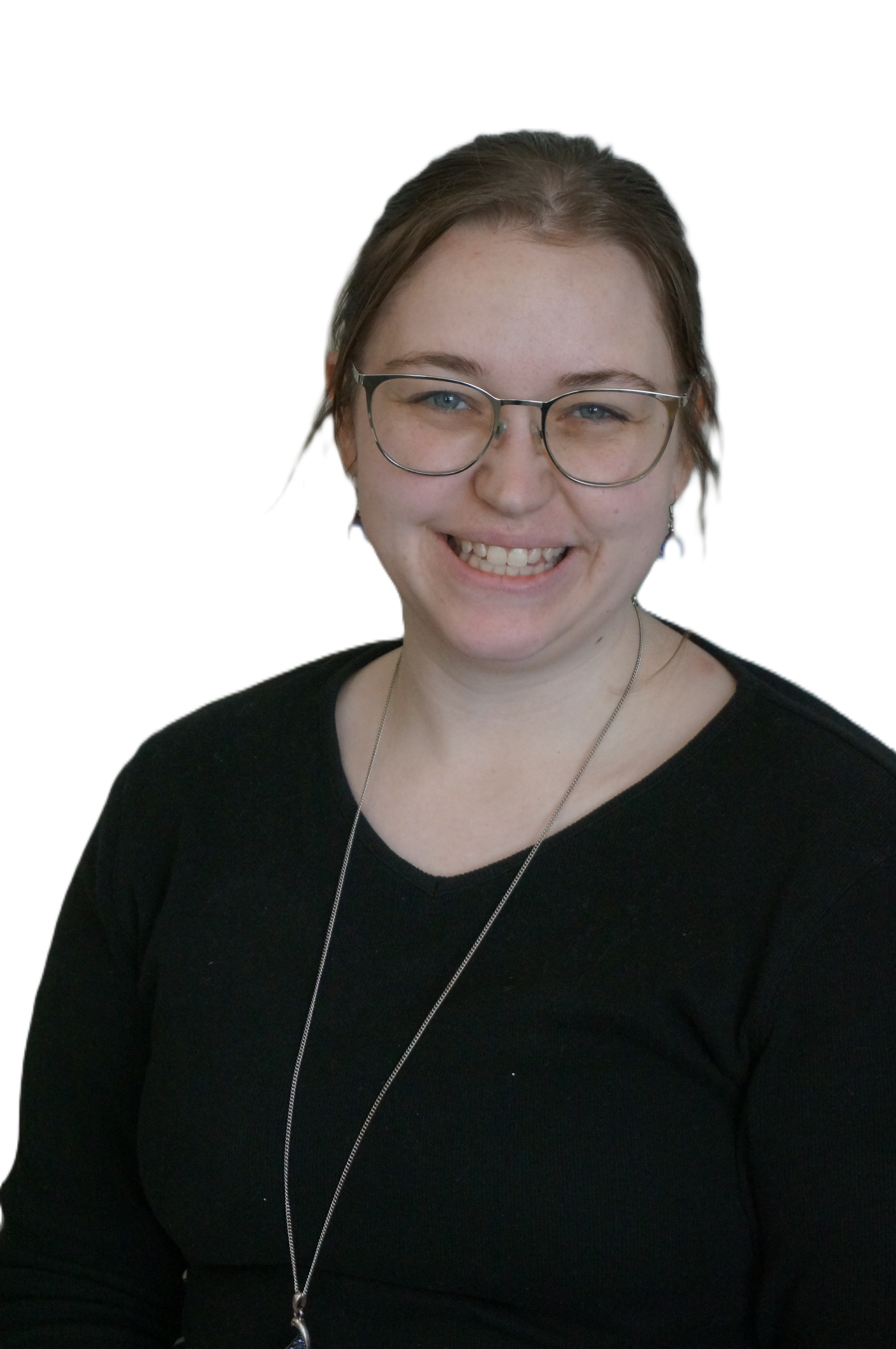 Portrait of a woman with glasses smiling, wearing a black top, earrings, and a necklace, against a dark background.