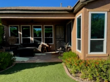 Backyard patio area with outdoor furniture and surrounding greenery