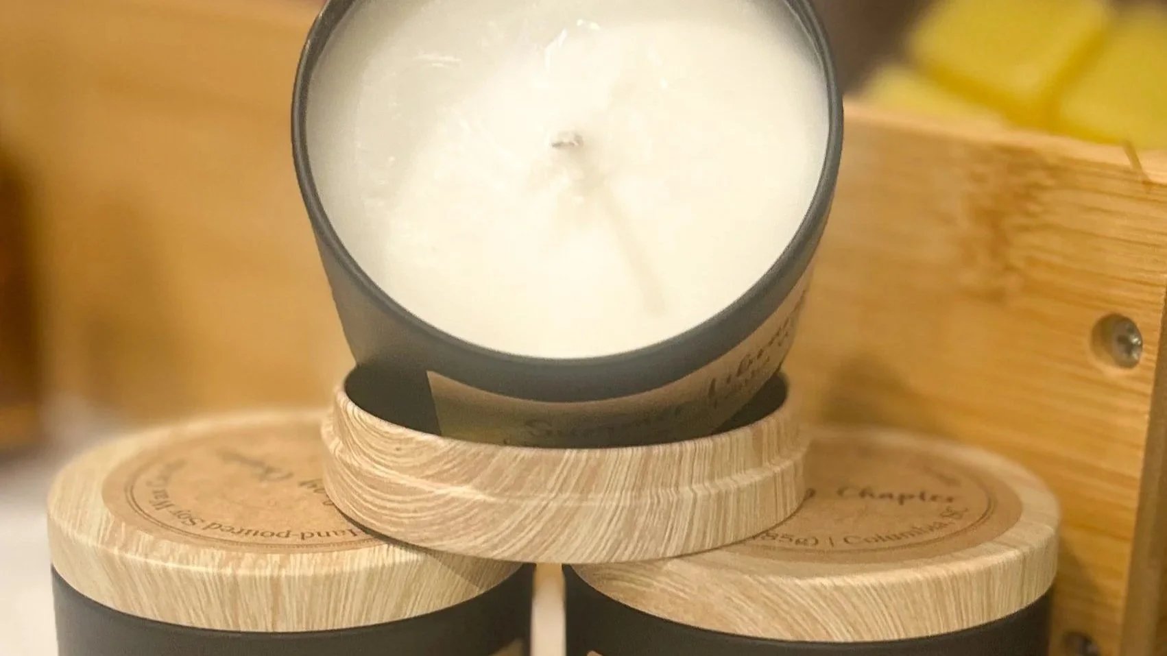 Picture of small candles with white wax and wood background