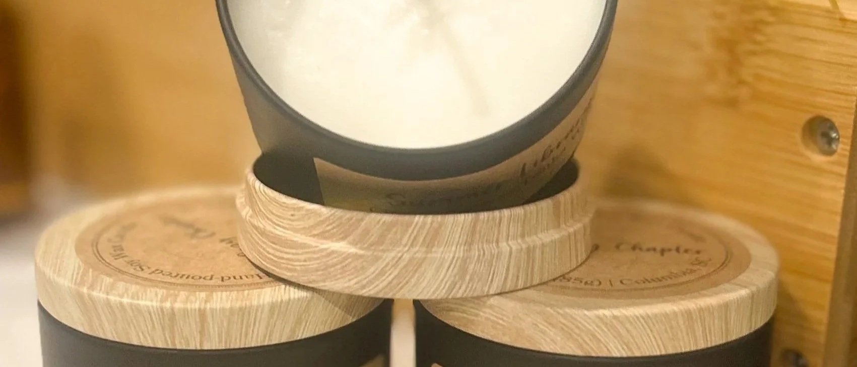 Picture of small candles with white wax and wood background