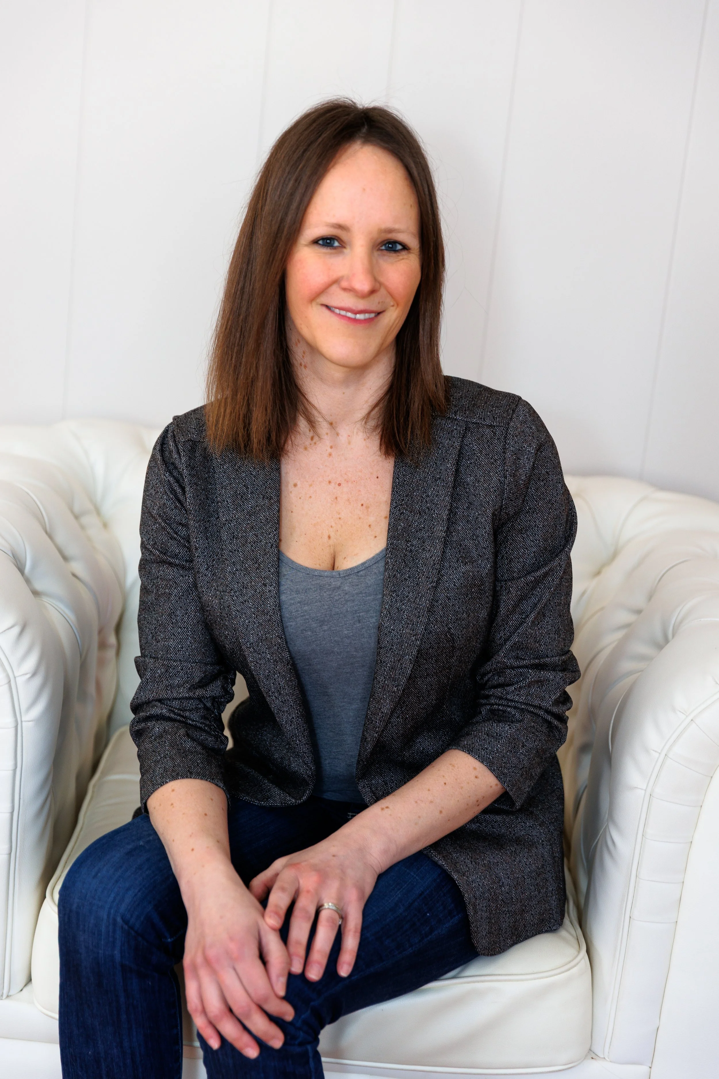 Janina Grayeb owner of Generative Reach sitting in white chair