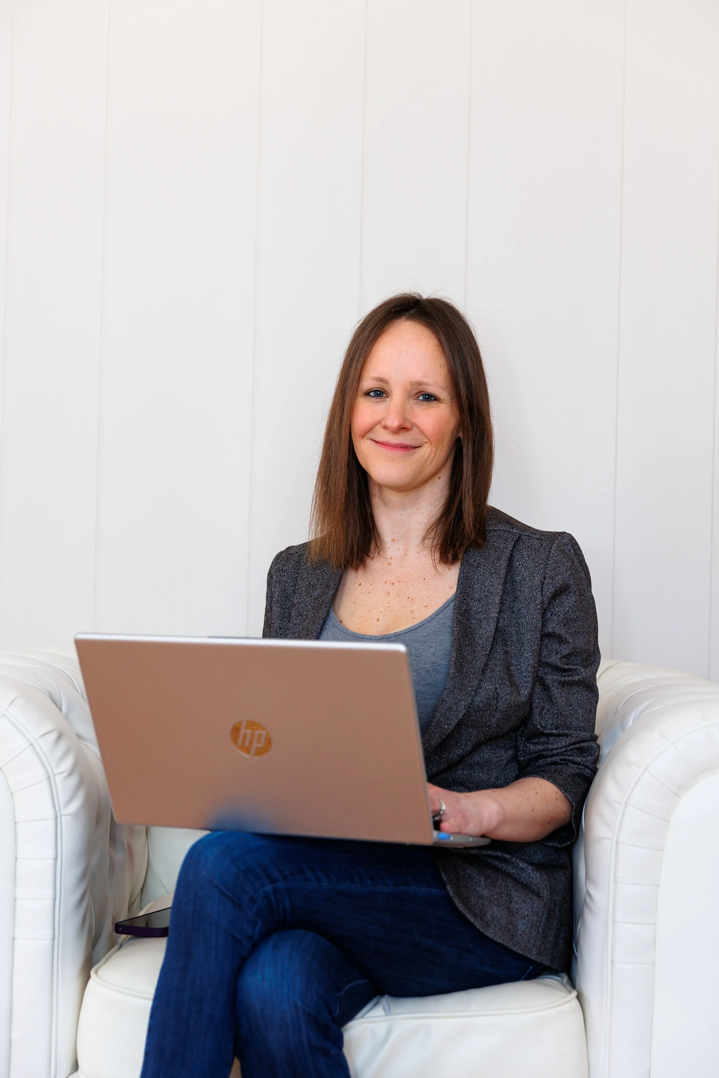 Janina with her laptop sitting in a chair