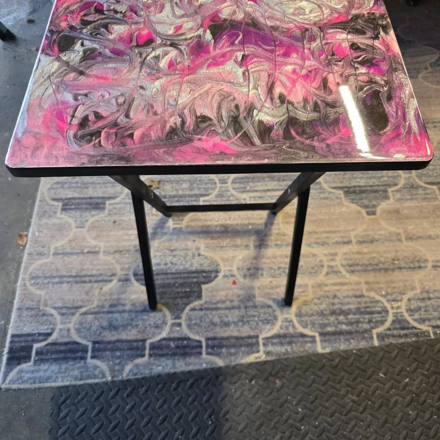 ✨New Piece Finished!✨

This folding accent table got a complete makeover with a custom epoxy top in bold pink, silver, black, and purple swirls 💕🖤💜. The colors shift and shine differently depending on the light, making it a statement piece for any
