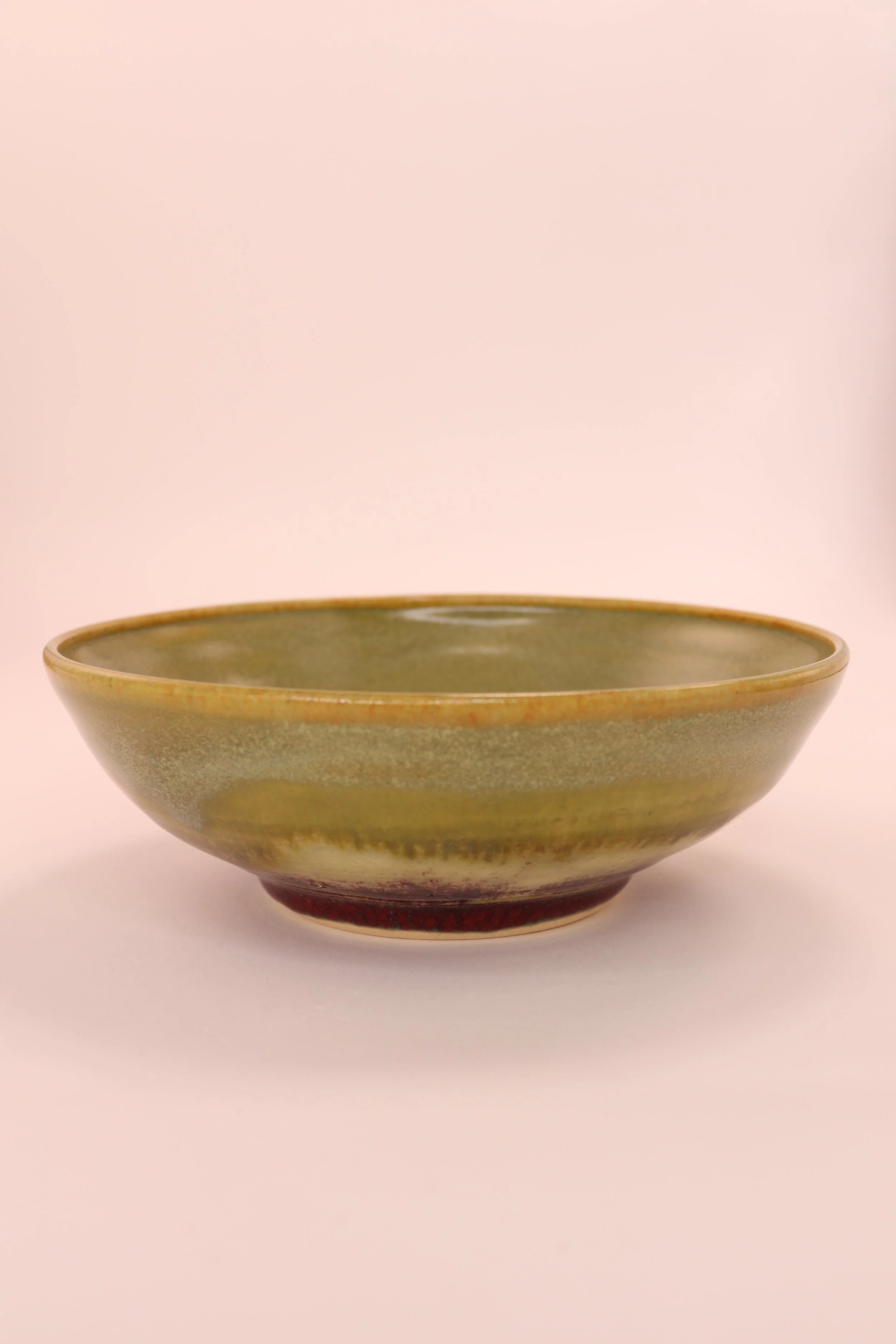 Shallow pale green bowl, with red glaze