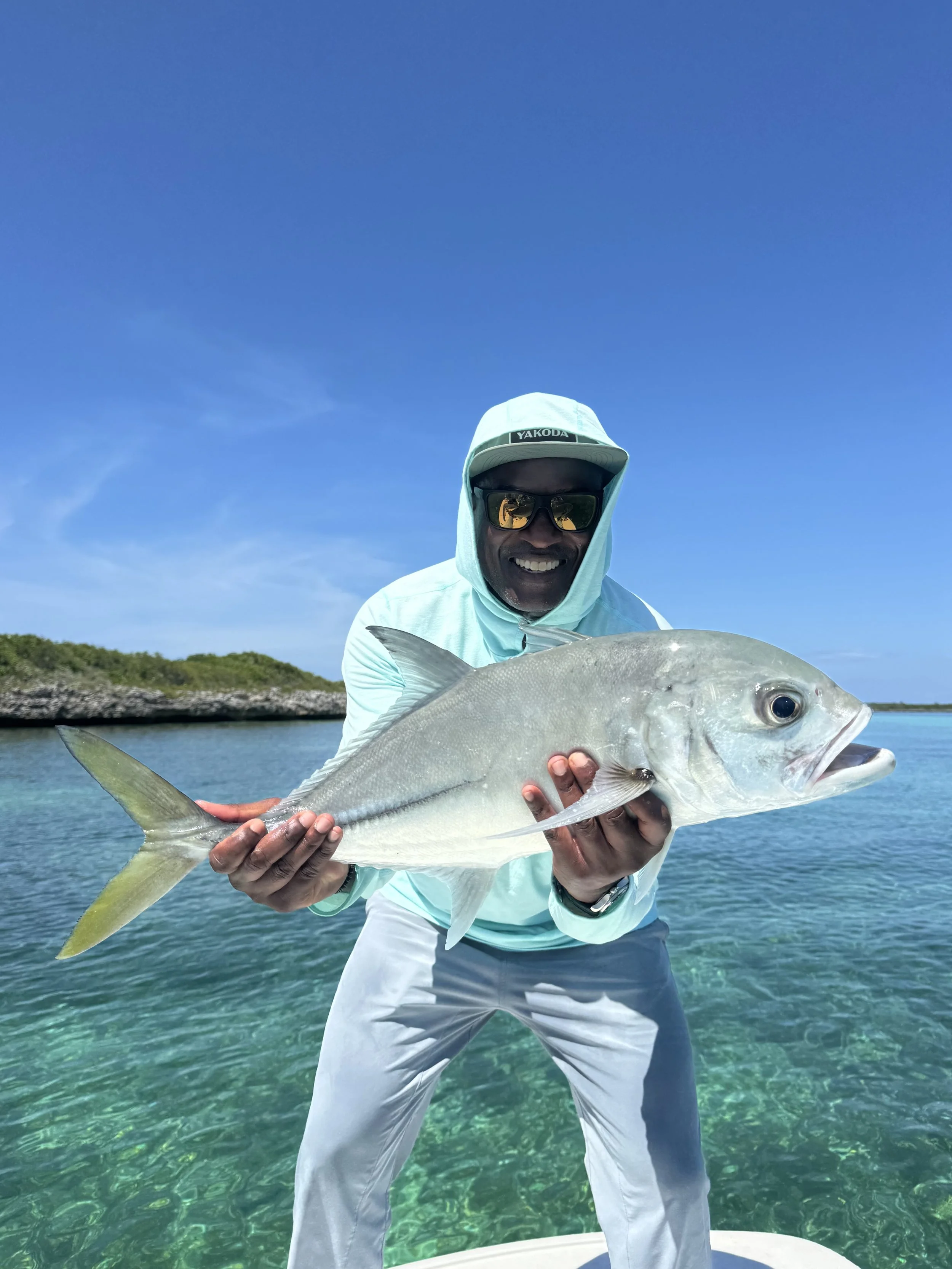 Angler holding a large horse-eye jack during a guided fishing trip in Abaco, Bahamas.