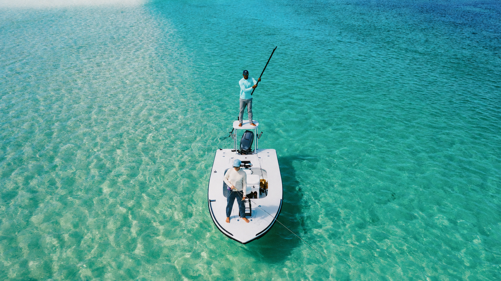 Aerial view of angler and guide fishing from a flats skiff in the clear waters of Grand Bahama, Bahamas.