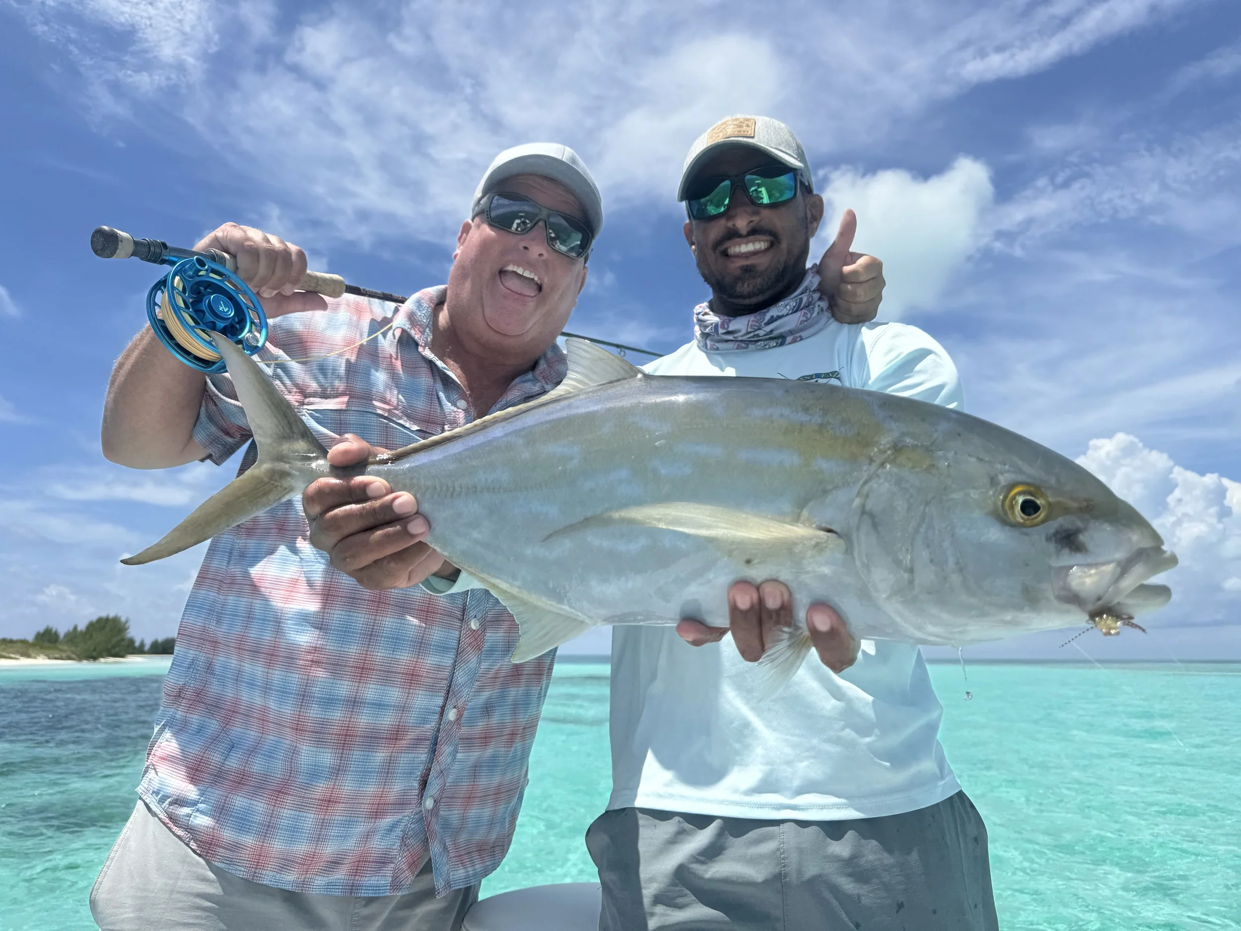 Angler and guide Justin Lewis celebrating with a large yellow jack caught while fishing the waters of Grand Bahama.