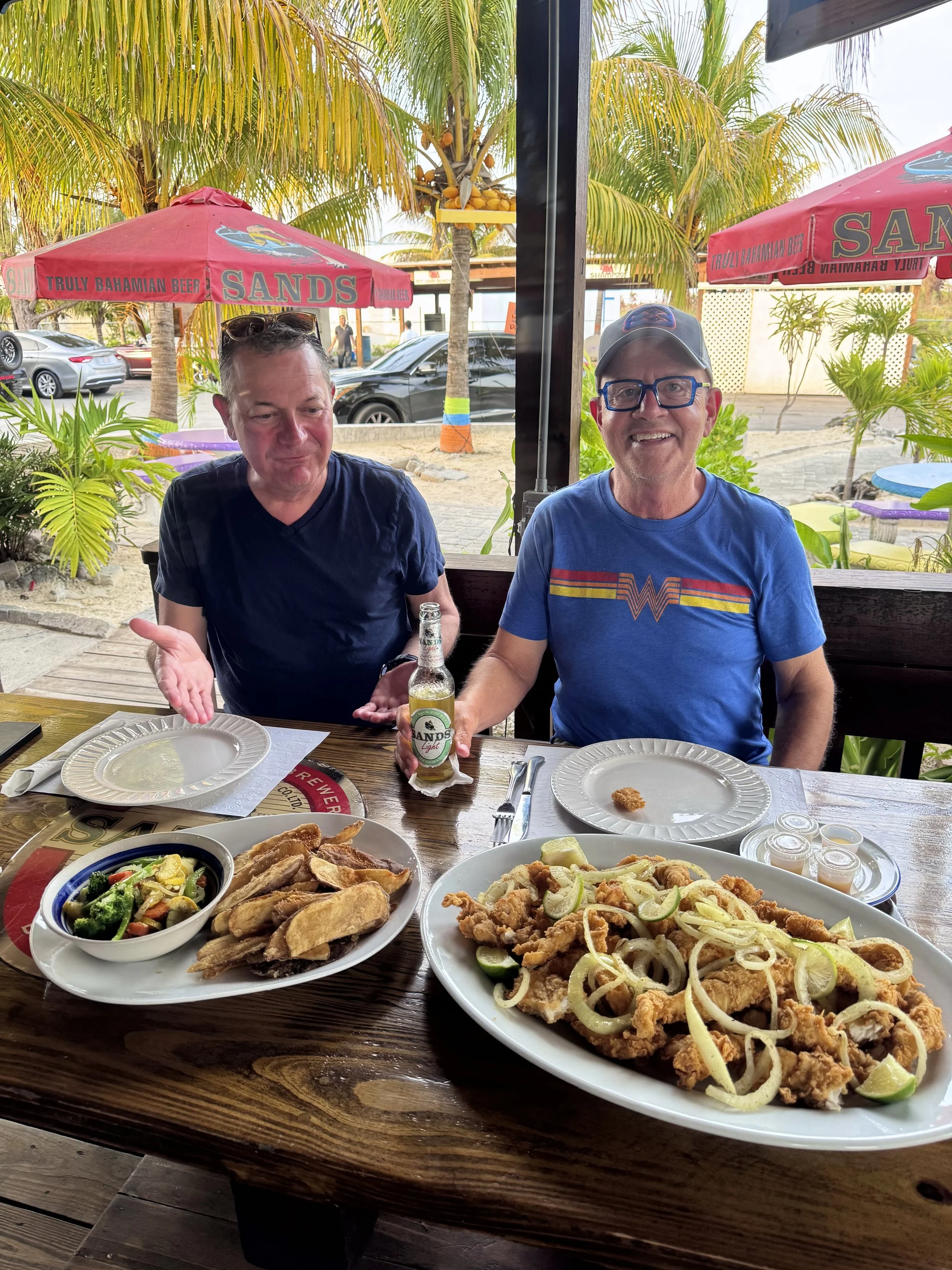 Guests enjoying a fresh-catch meal at a local restaurant in Grand Bahama, Bahamas.