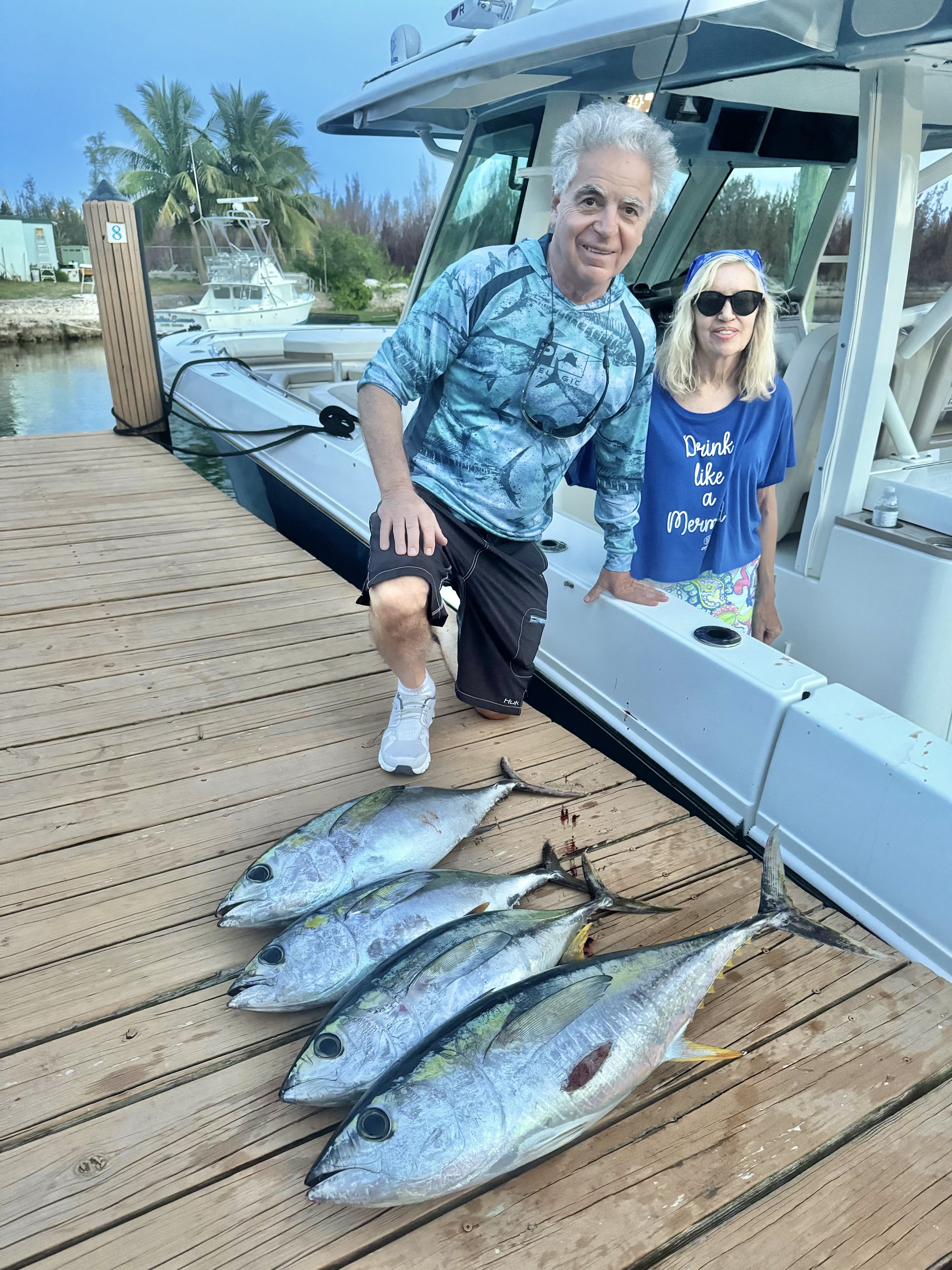 Guests showing off their catch of tuna after a guided fishing trip in Grand Bahama, Bahamas.