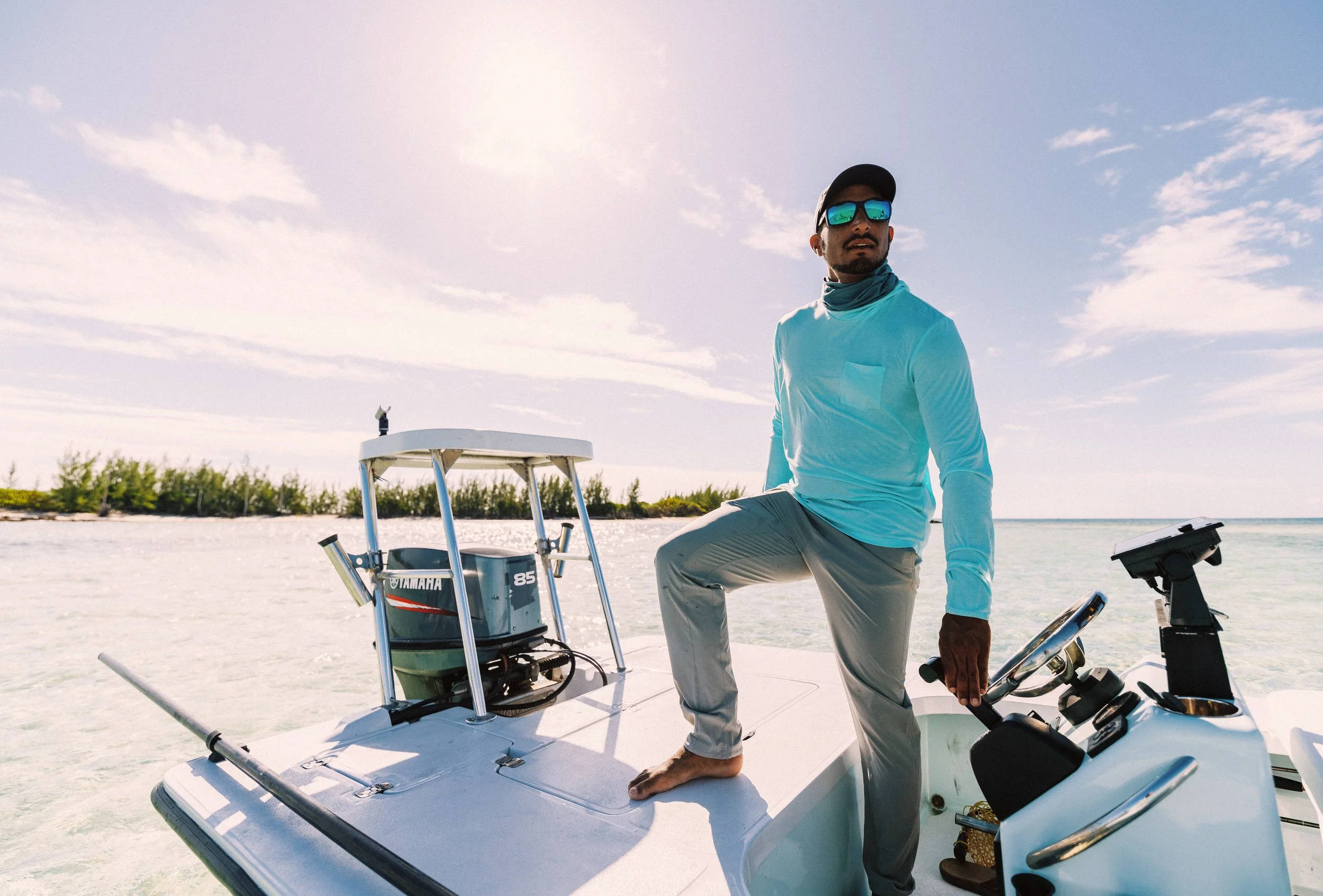 Fishing guide Justin Lewis standing aboard his Maverick flats skiff in Grand Bahama, Bahamas.