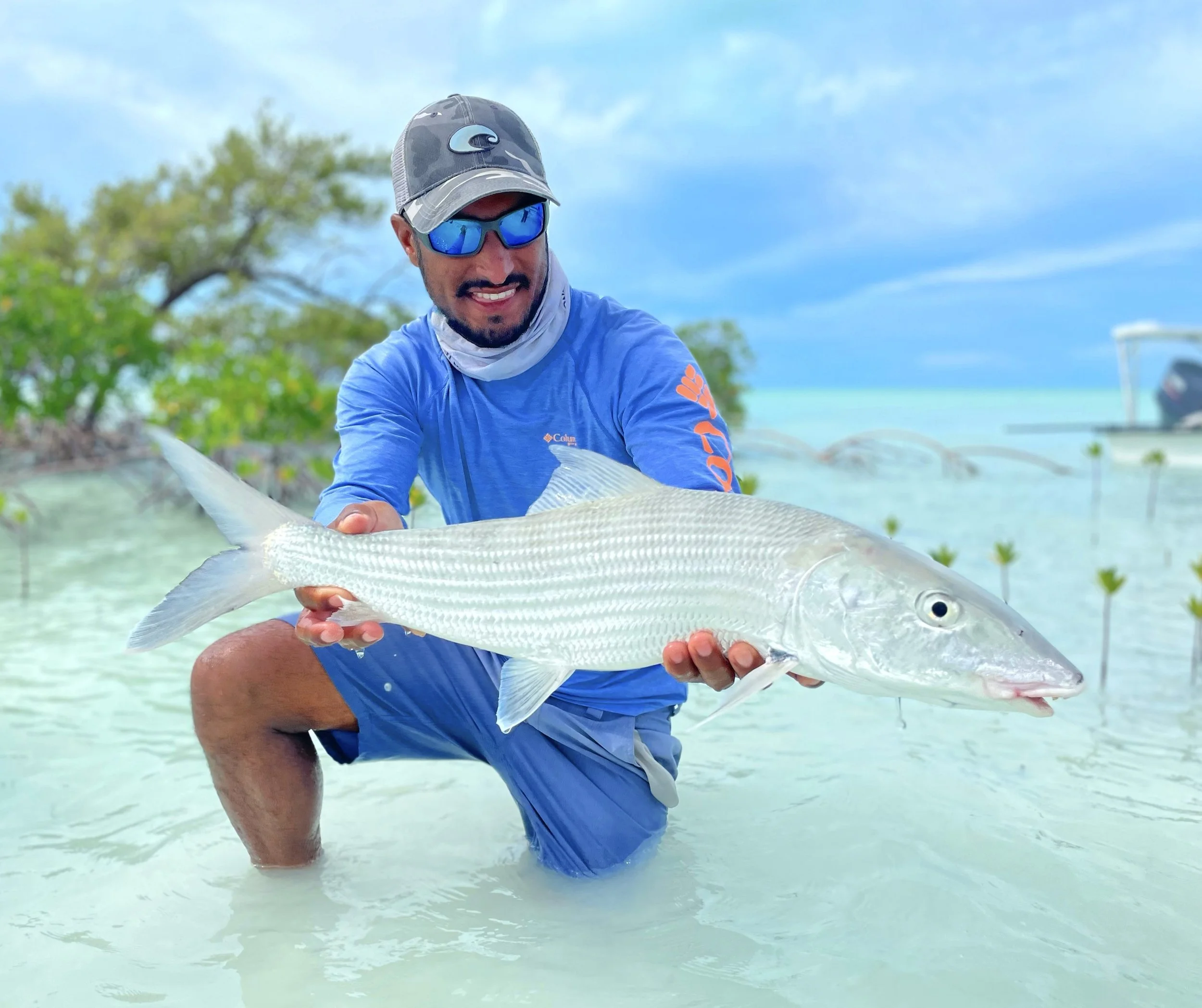 Captain Justin Lewis holding a trophy double-digit bonefish caught on the flats of Grand Bahama, Bahamas.