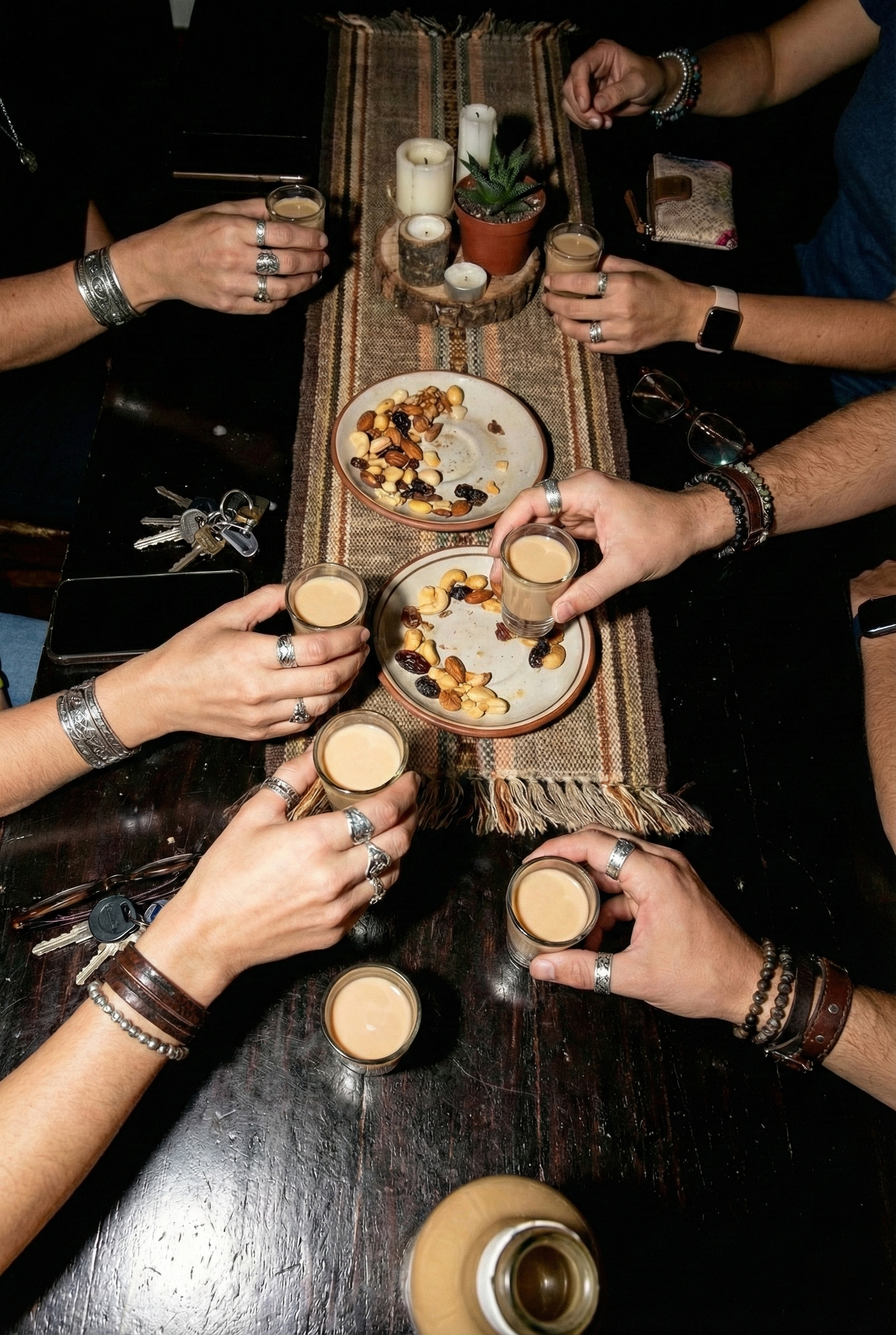 Amigos brindando con shots de crema de pisco 7 Pecados Pereza de Café en reunión nocturna, licor premium peruano ideal para celebraciones y momentos exclusivos.