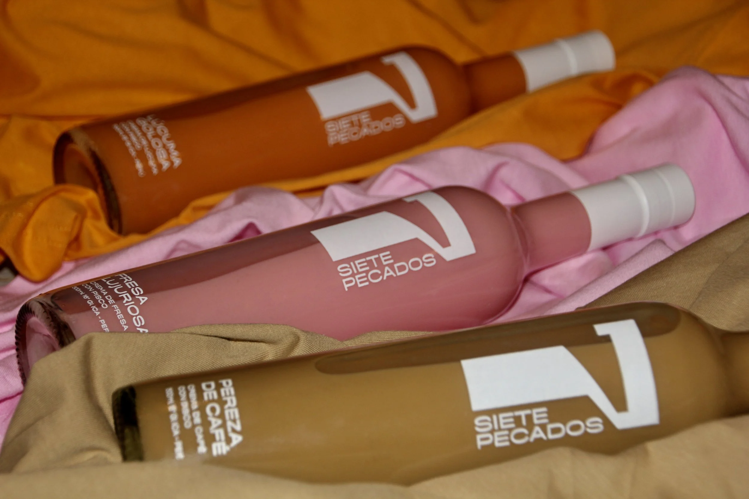 Scenic view of a lake surrounded by mountains and rolling grassy hills under a cloudy sky.