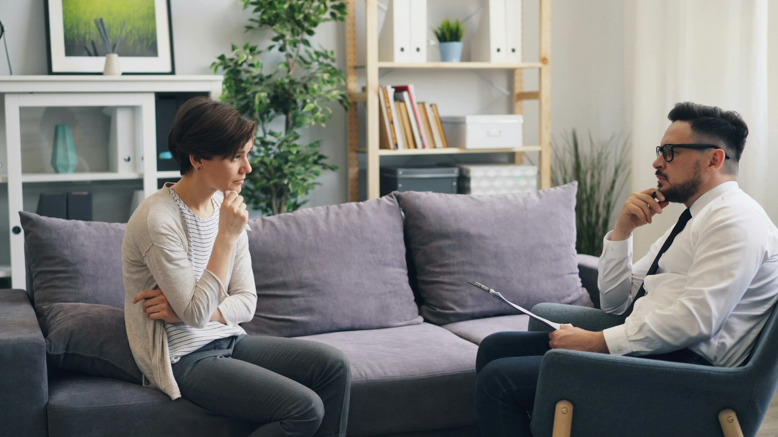 Person sitting on couch receiving therapy for religious trauma and spiritual abuse.