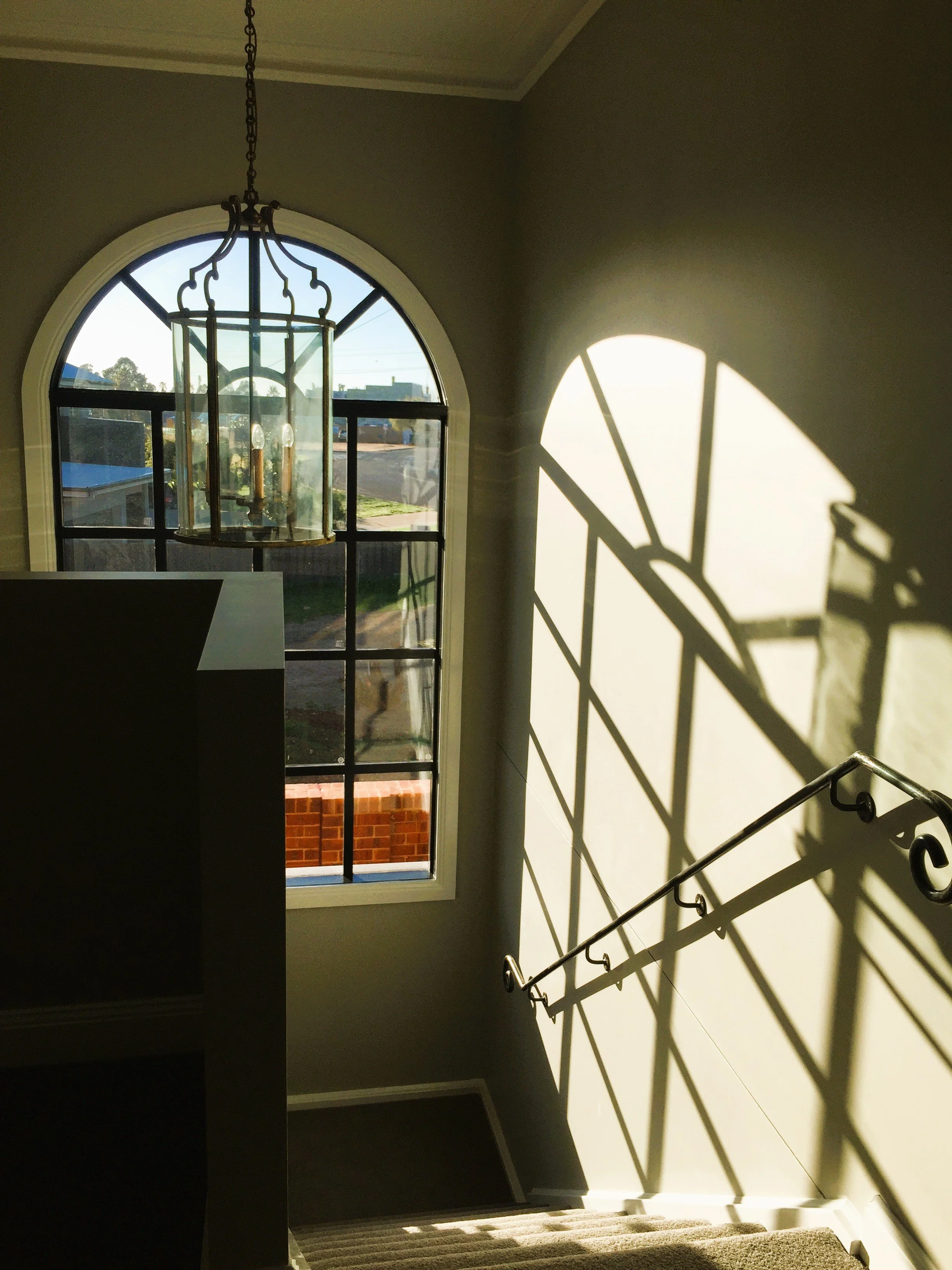 Arch window, pendant, wrought iron balustrade
