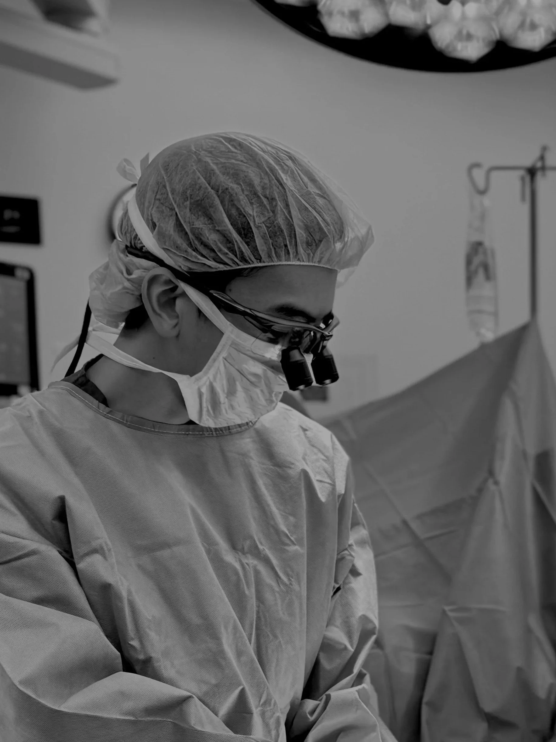 Dr. Justin Cheng, a plastic surgeon in Honolulu, Hawaii, performing surgery while wearing surgical loupes