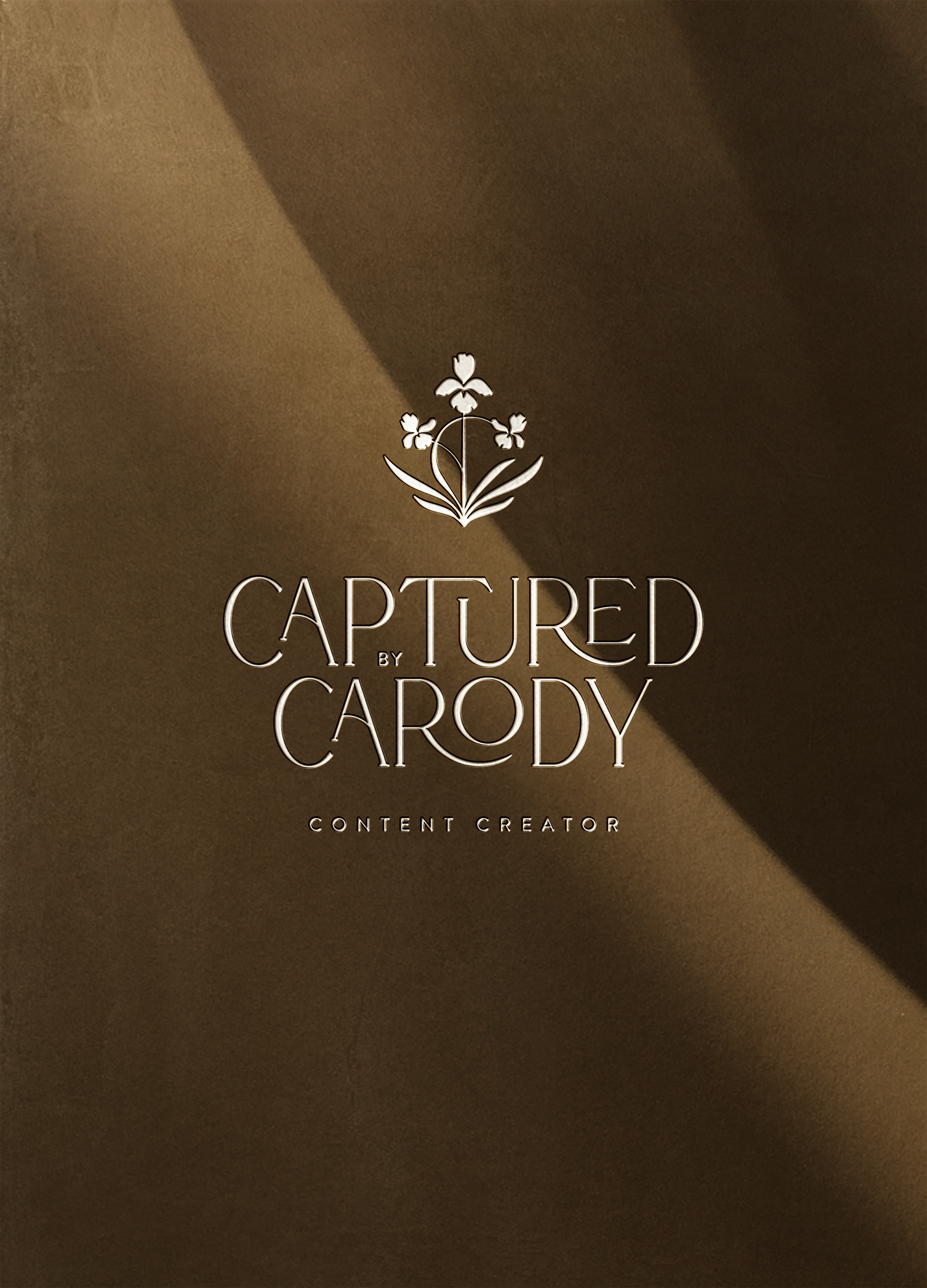 A logo with a floral design at the top, the words 'Captured by Cardy' in large font, and 'Content Creator' below, all on a brown background.
