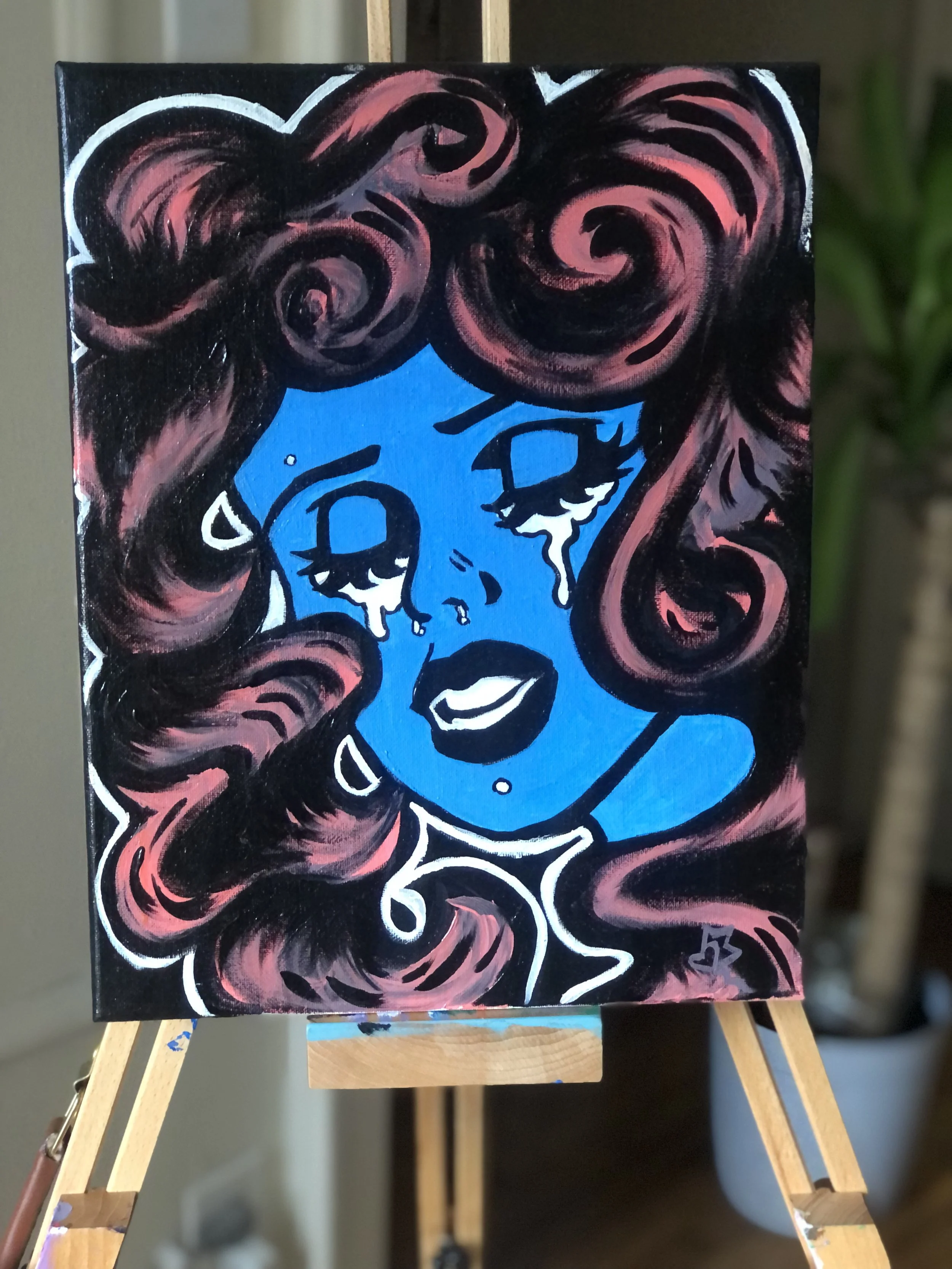 A colorful painting of a woman with dark pink, voluminous hair, blue skin, and emotional eyes with tears. The painting has bold black and white outlines and expressive brushstrokes.