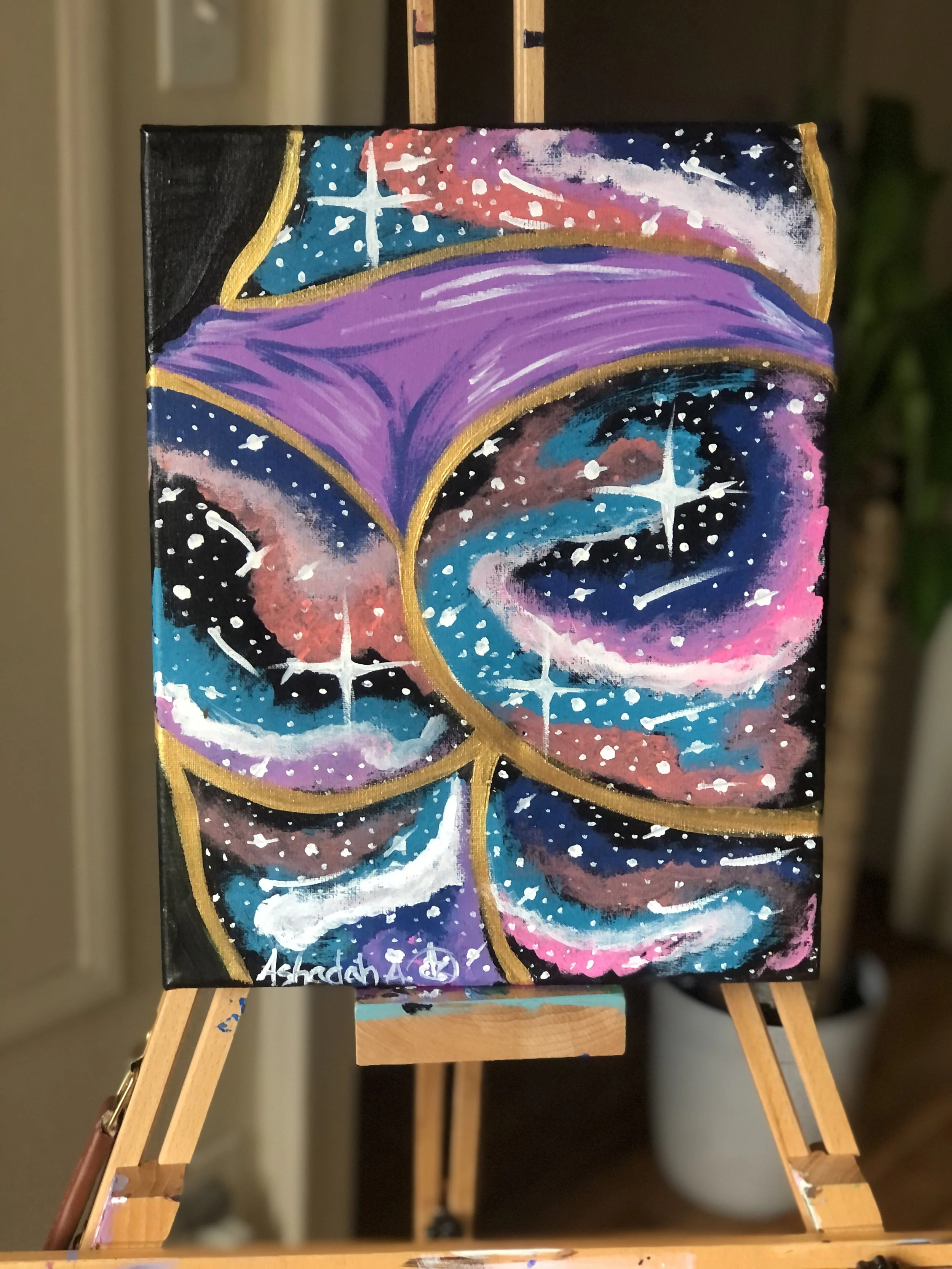 An abstract painting of a galaxy with colorful swirling patterns in purple, pink, blue, and black, outlined with gold accents.