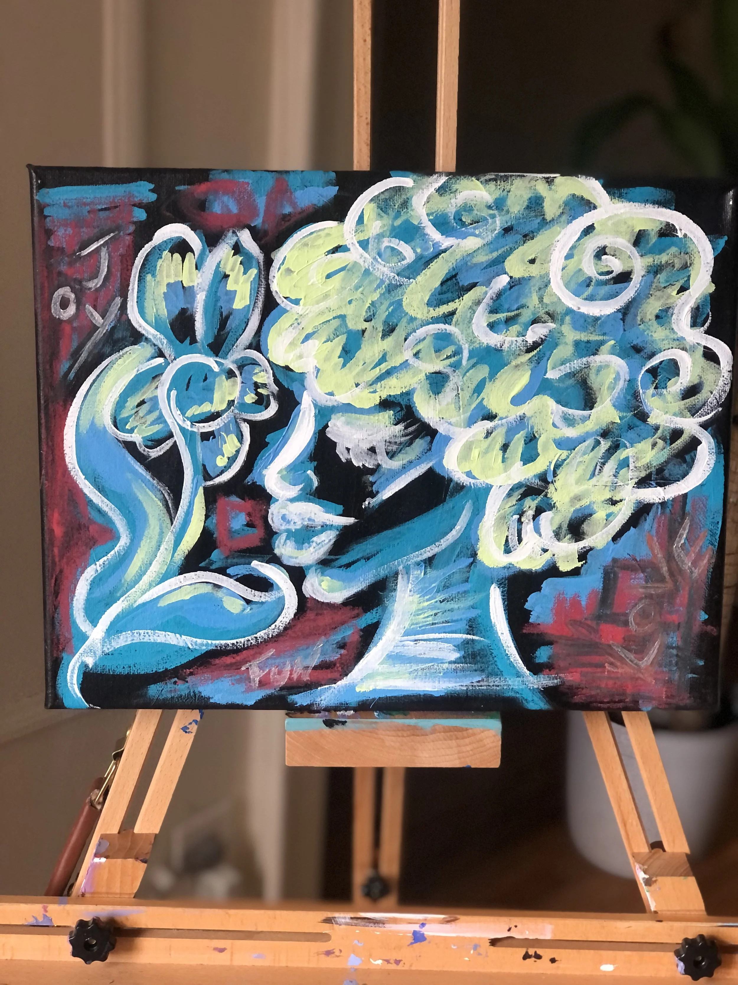 A colorful abstract painting on a small canvas depicting a woman with curly hair, holding a flower near her face, created with bold brush strokes and vibrant colors.