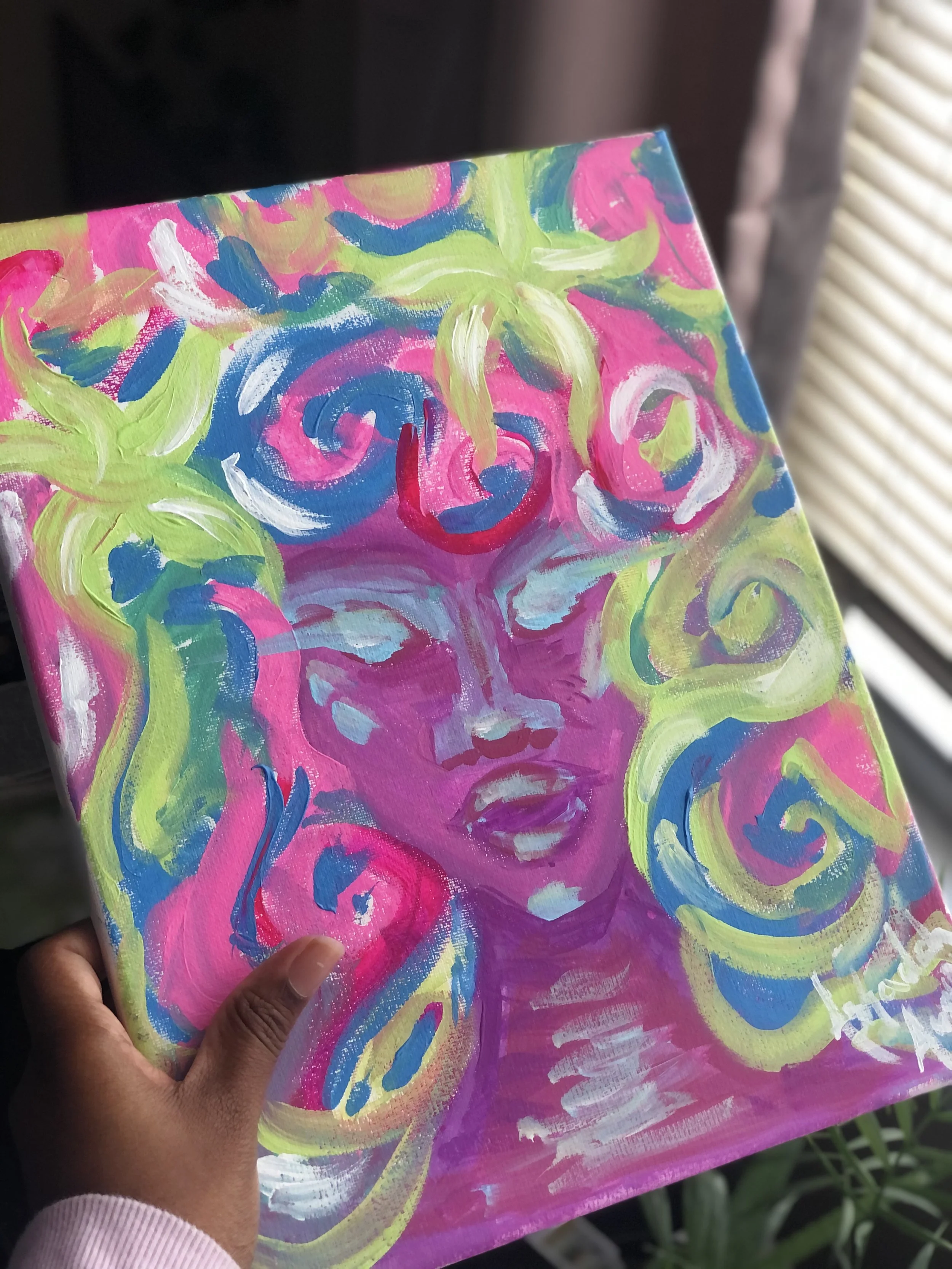 Colorful abstract painting of a woman's face with swirling hair, made with bright pinks, blues, greens, and whites.