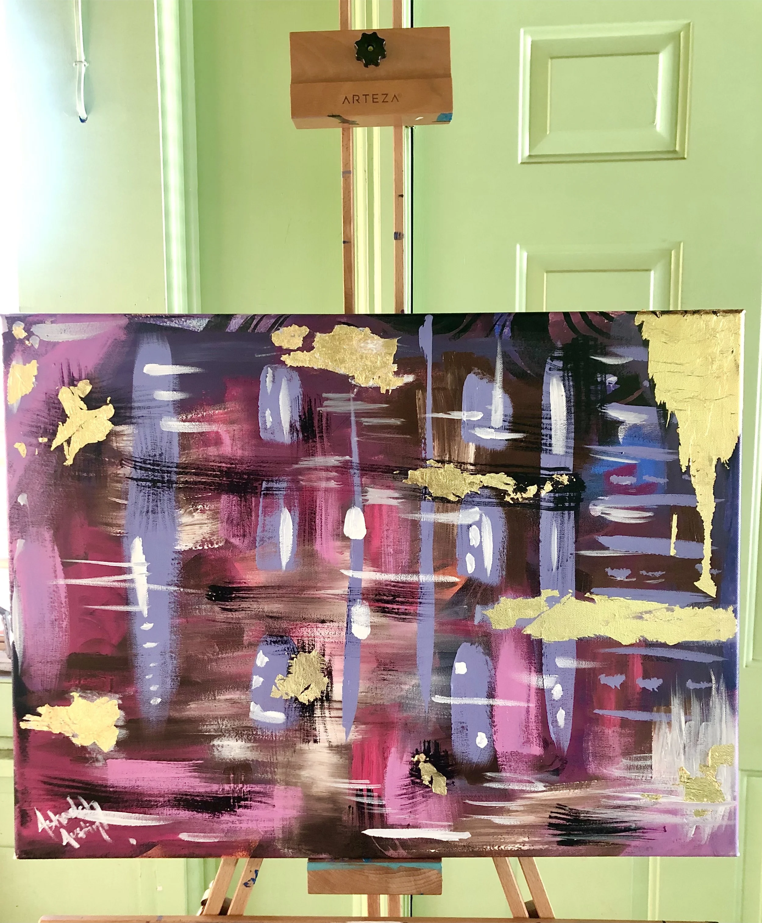 Abstract painting with pink, purple, black, white, and gold brushstrokes on a canvas.