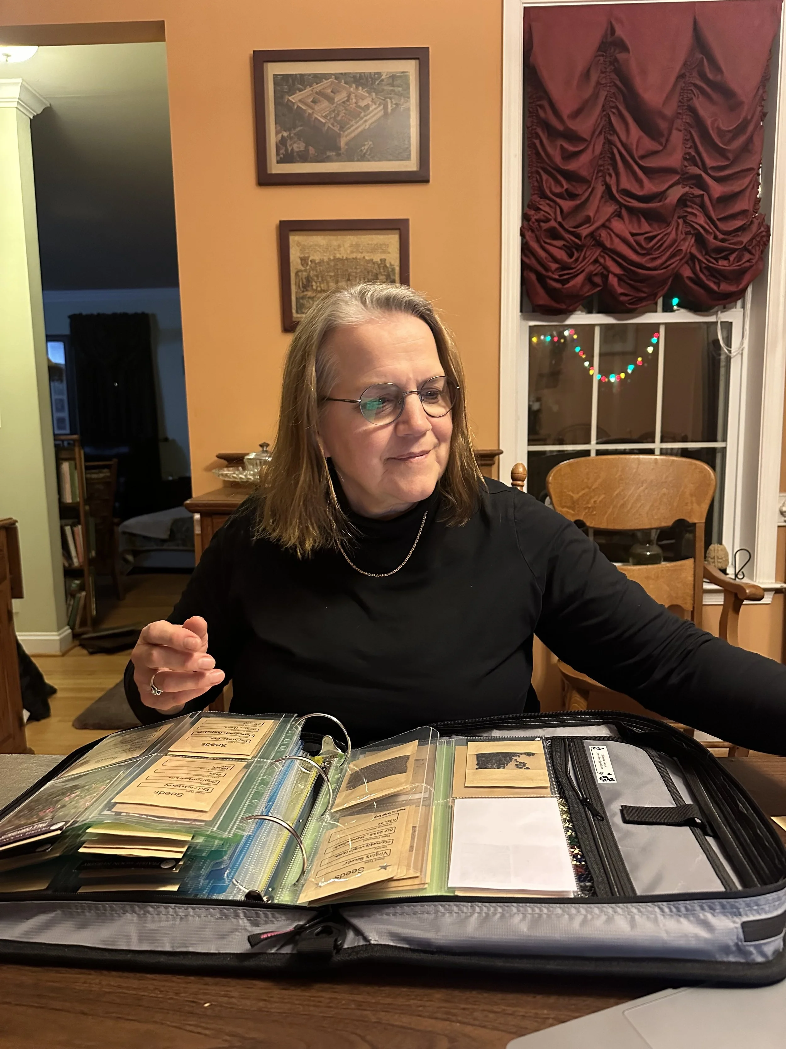 Deb picks seed packets out of Miranda's seed binder for stratification.
