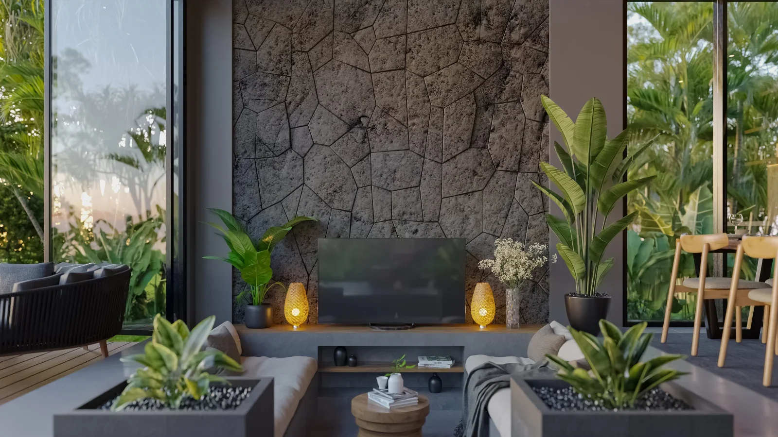 Modern living room with a stone accent wall, large windows showing greenery outside, potted plants, a television, and decorative lamps.