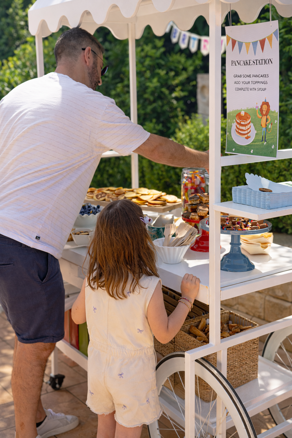 Guests enjoying a pancake catering station and coffee cart by 10 Pounds at an outdoor event.