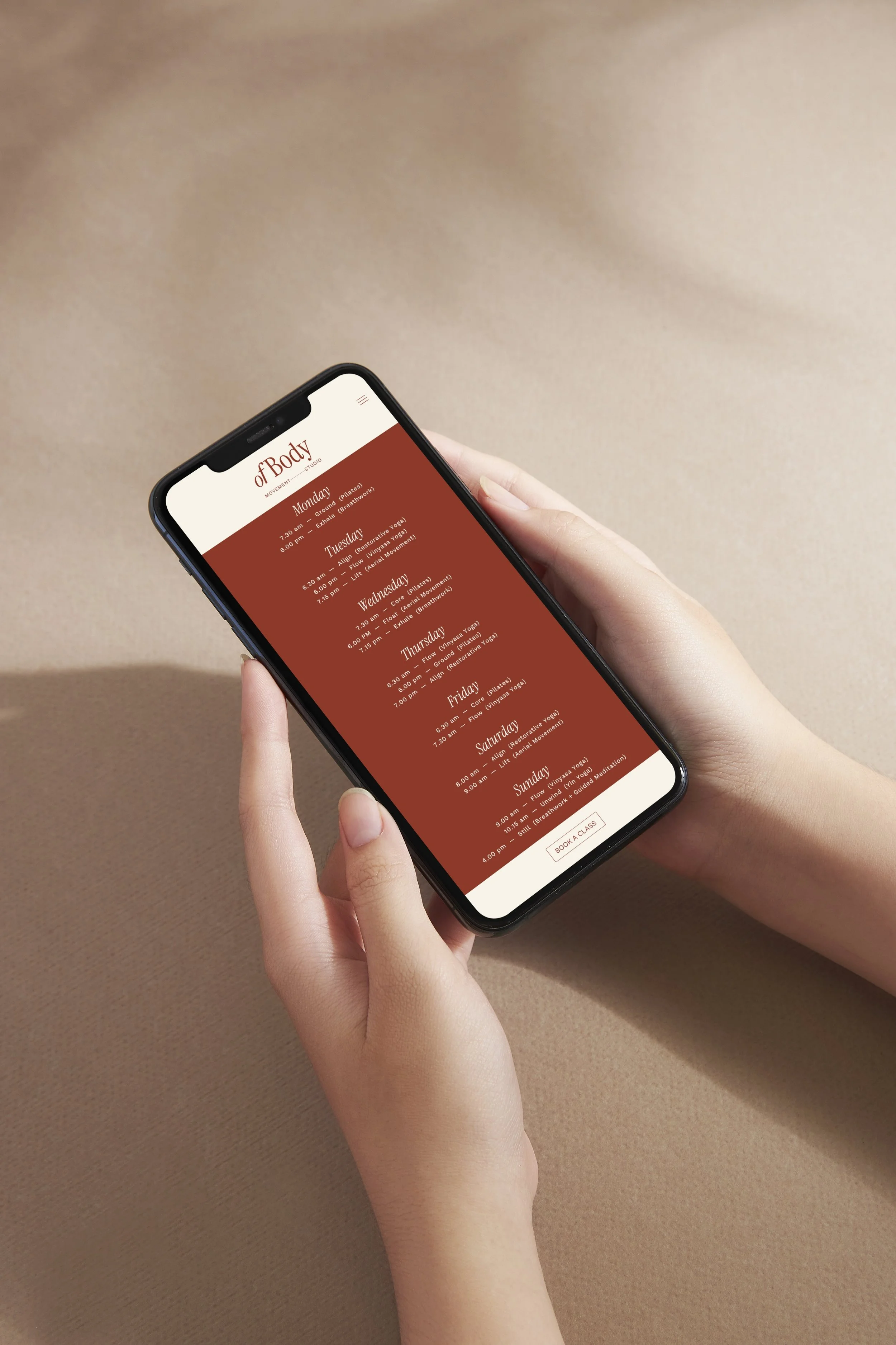 Elevated mobile website mockup showing class schedules for a modern pilates and yoga studio. Responsive UI design by Melbourne branding agency
