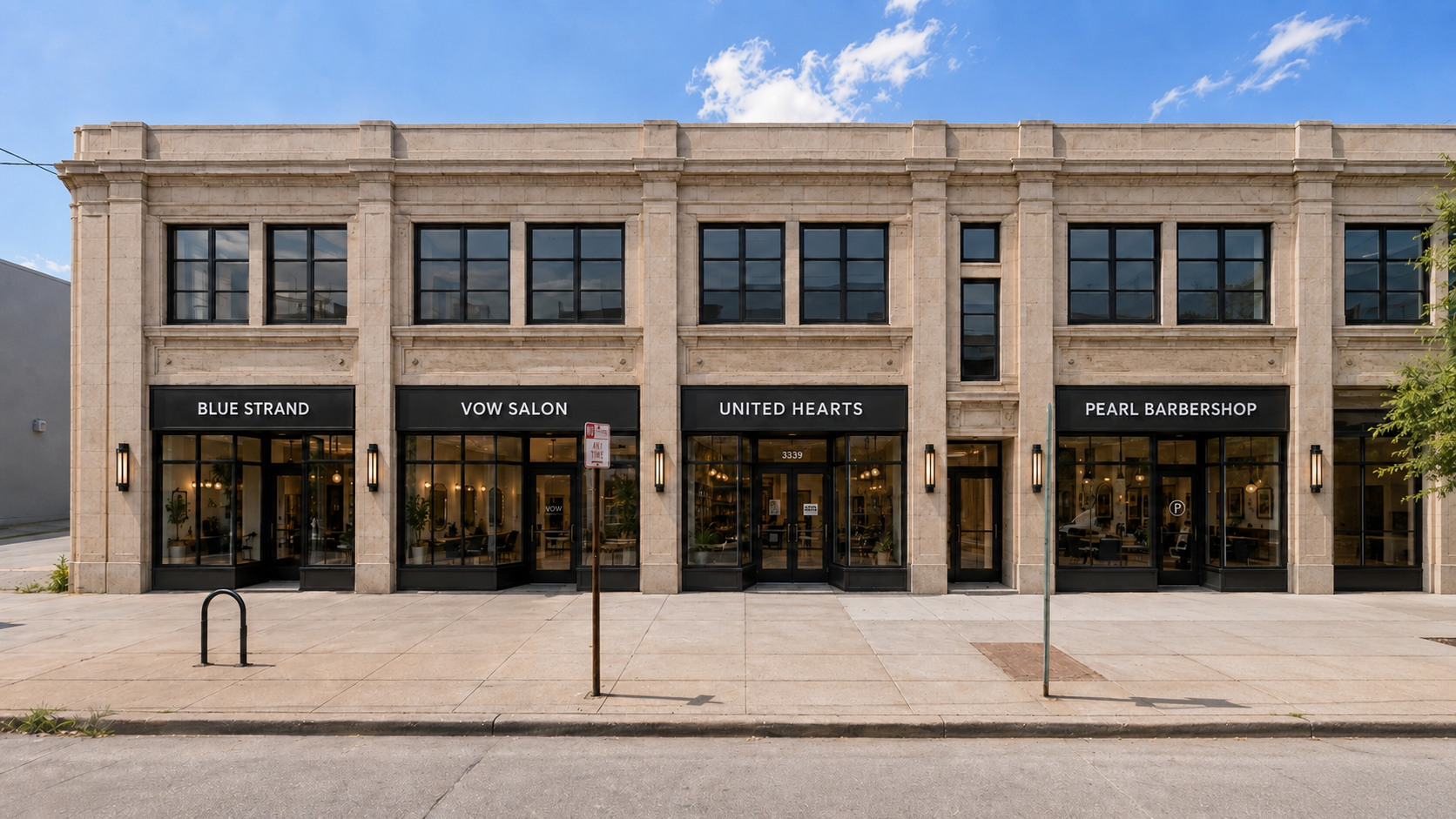 A modern three-story building with storefronts for Blue Strand, Vow Salon, United Hearts, and Pearl Barbershop, featuring large windows and black signage, on a sunny day with a partly cloudy sky.